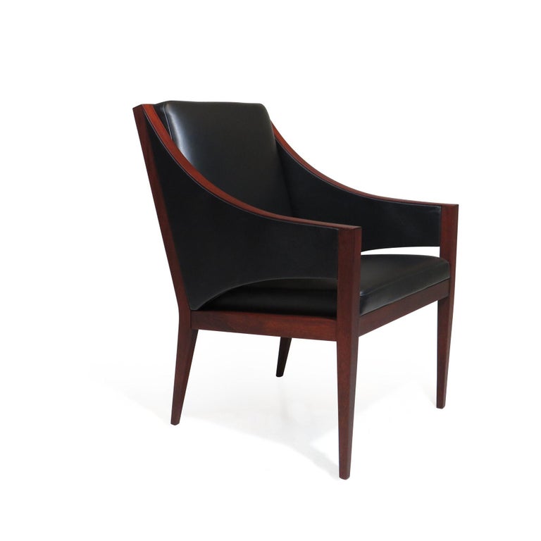 Pair of mahogany lounge chairs with elegant sloping arms newly upholstered in a high-quality black leather.
The chairs are in excellent condition with minor signs of age and use.
 
Seat Height 19''.
