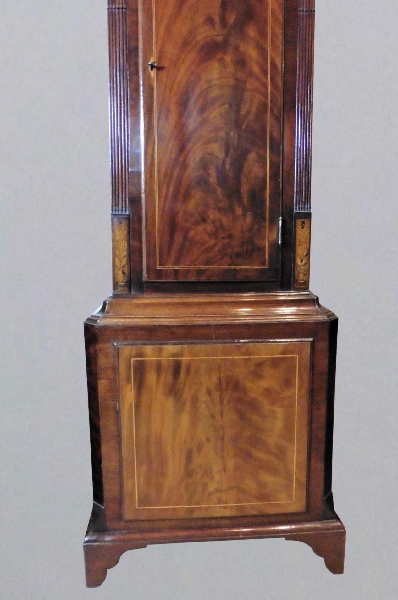 Mahogany Longcase Clock with Rocking Ship Automation. Robert Fletcher, Chester

Fine flame mahogany case, the hood with swan neck pediment, carved patrae, turned and reeded pillars with Corinthian capitals. Corner quadrants with inlaid shell