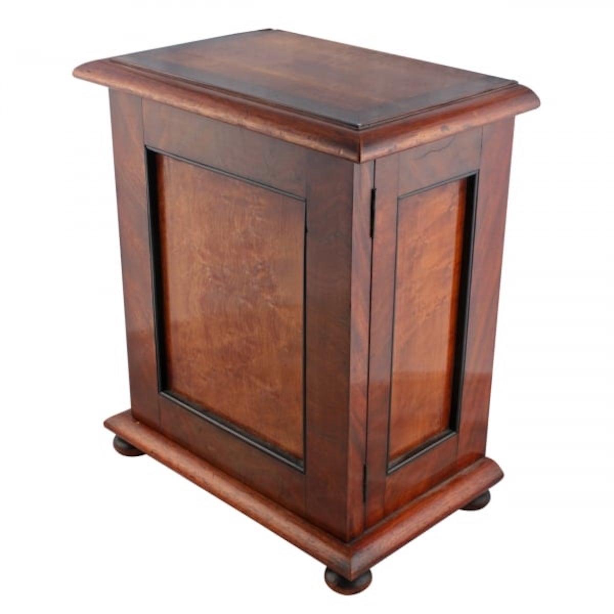 A middle of the 19th century mahogany table cabinet.

The cabinet has panels of birds eye maple and the door and side panels have ebony beading.

The interior has two short drawers and three long drawers that are mahogany lined and have turned