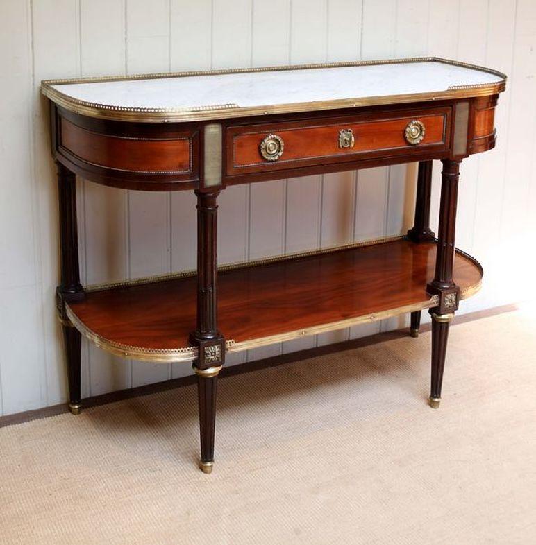 Mahogany marble top console/desserte table designed after the Martin Carlin 18th century model, having a veined white marble top with pierced brass gallery above a central drawer with bow shaped ormolu escutcheons and handles and acanthus wreaths