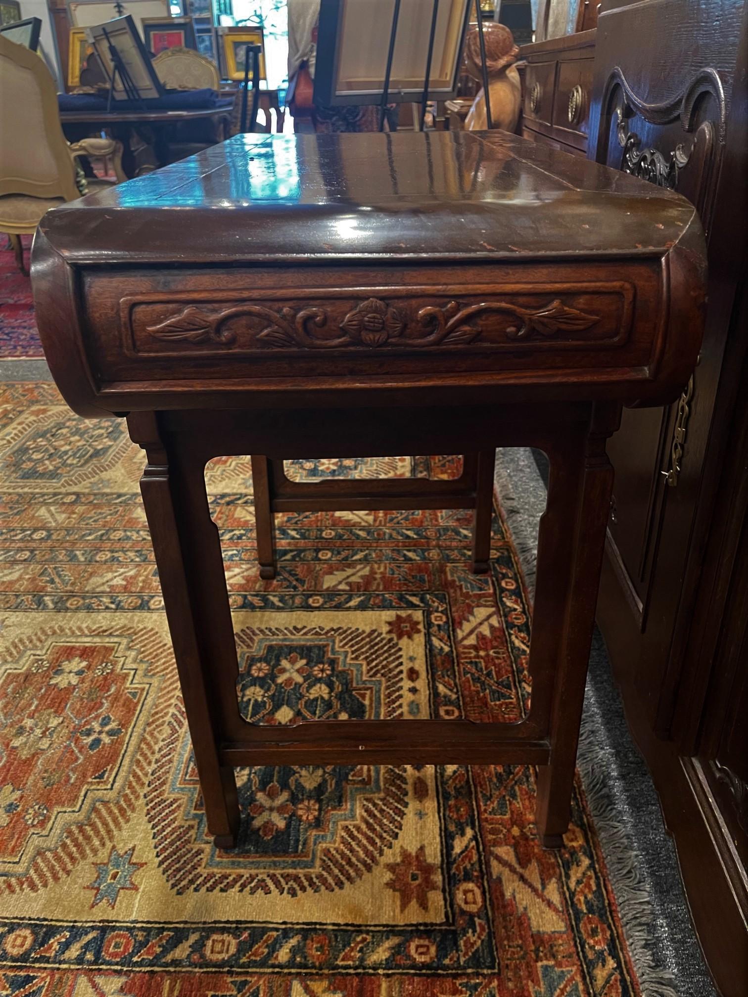 A mahogany Ming Chinese altar table with sides carved and decorative carvings on legs, Early 20th Century.