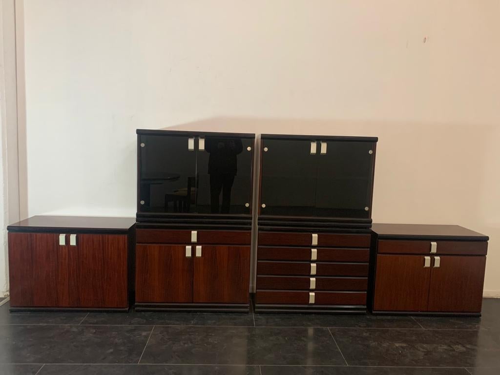 6 modular and fully separable cabinets, without any signs of joints, in rosewood ebonized profiles with burnished glass. Chrome-plated metal handles and fittings. Excellent quality, including packing in boxes. 
6 modular and fully separable