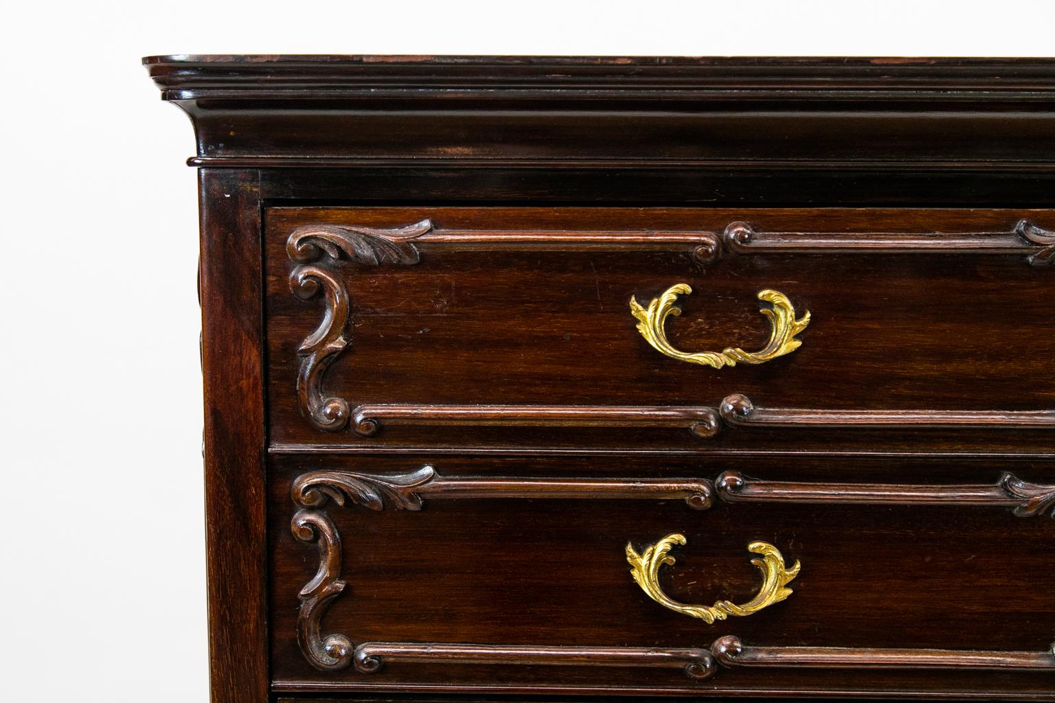 Mahogany music cabinet, the drawers lined with solid mahogany. There are carved moldings on the drawers and sides. The cabriole legs have acanthus leaf carvings terminating in French scrolled feet. The drawer fronts fold down to access music scores.