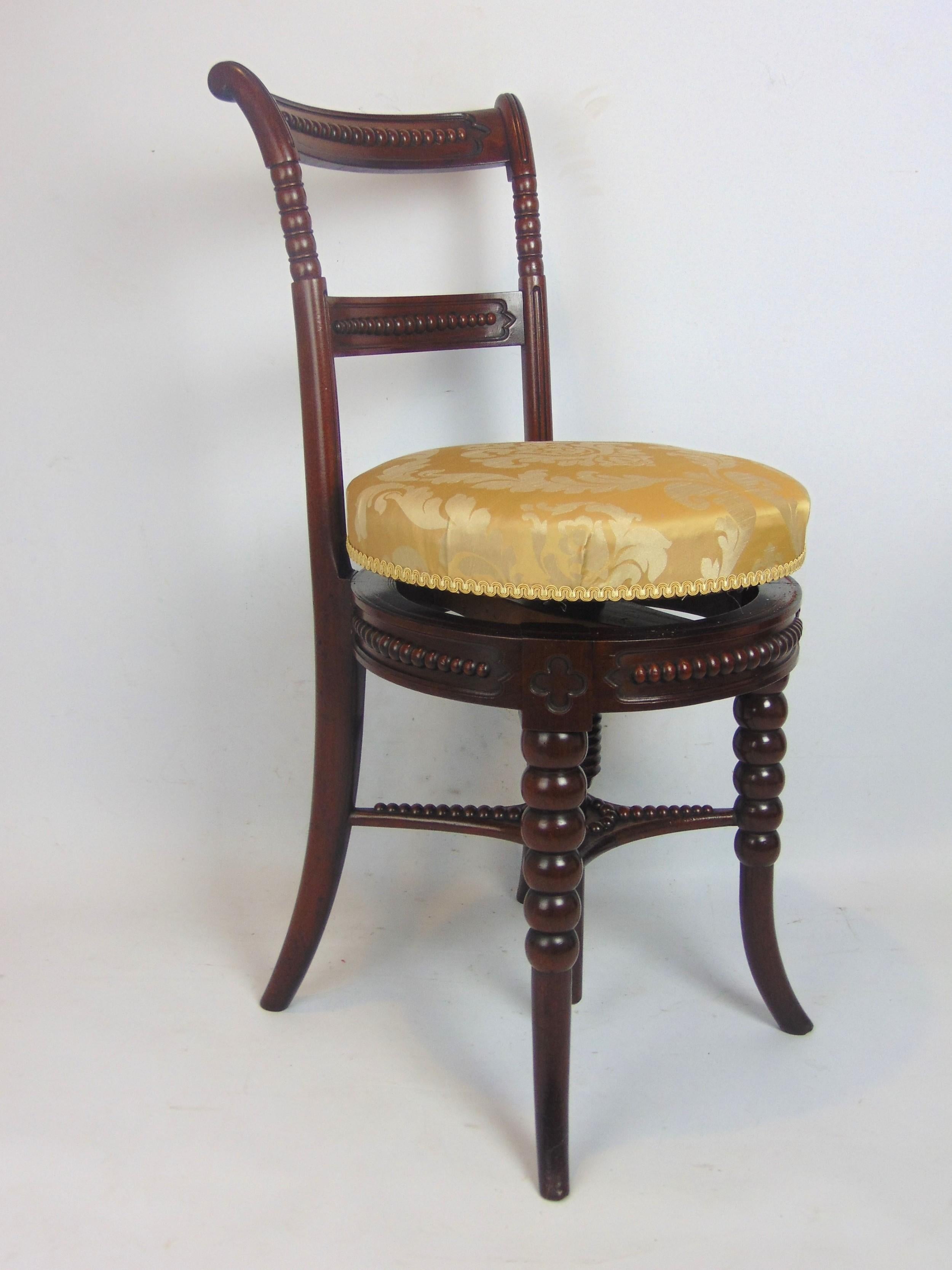 Music Stool  Antique Chair English revolving seat having half round carved detail to the recessed cartouche style back out, the seat revolves from 50cm seating height up to 65cm to suite the musicians requirements and has been re-upholstered with