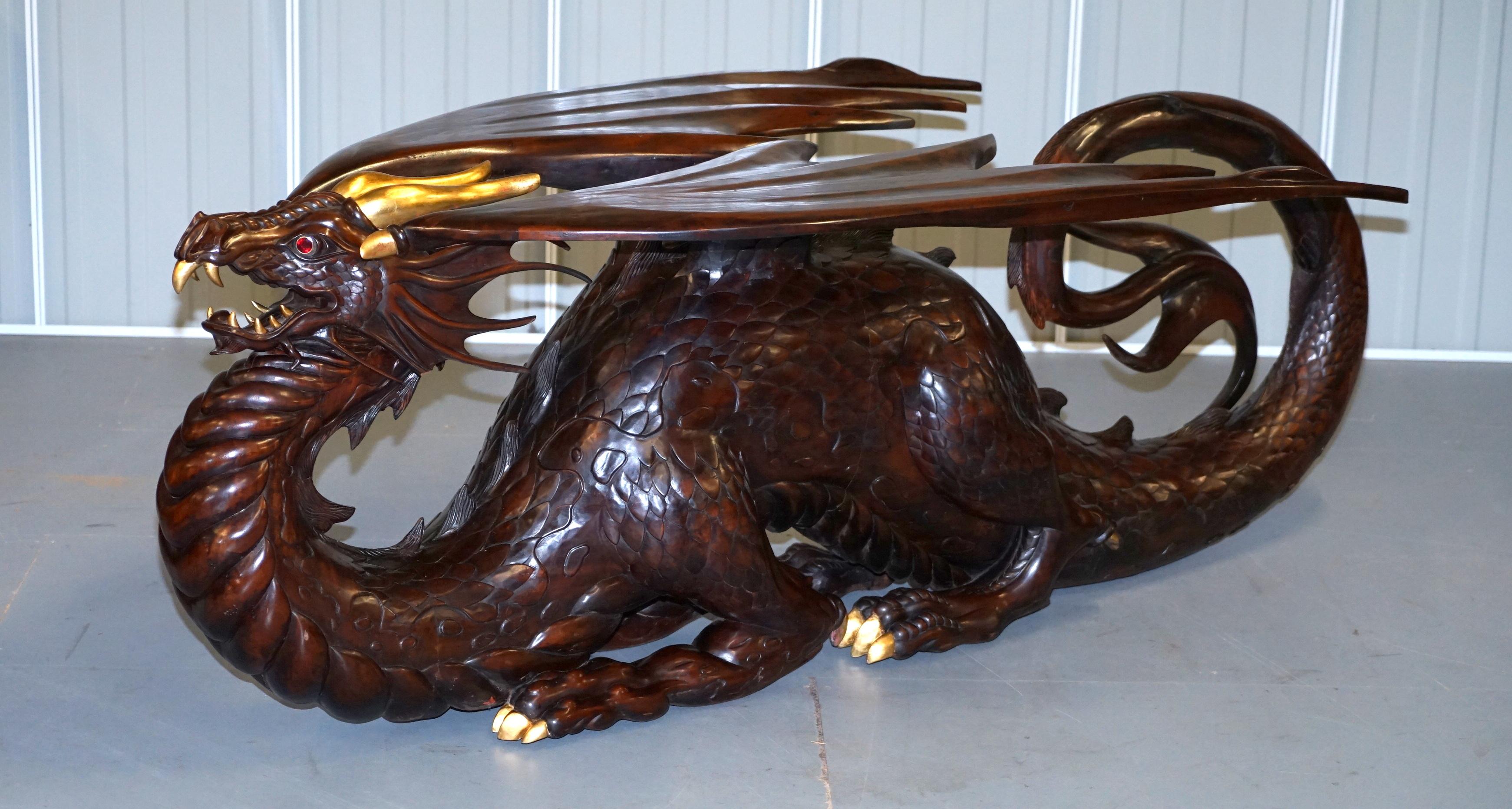We are delighted to offer for sale this one of a kind original Neil Busby solid mahogany Dragon dining table with 22-carat gold detailing and huge Ruby eyes 

I have the matching, again one of a kind suite of 12 Dragon dining chairs which has the