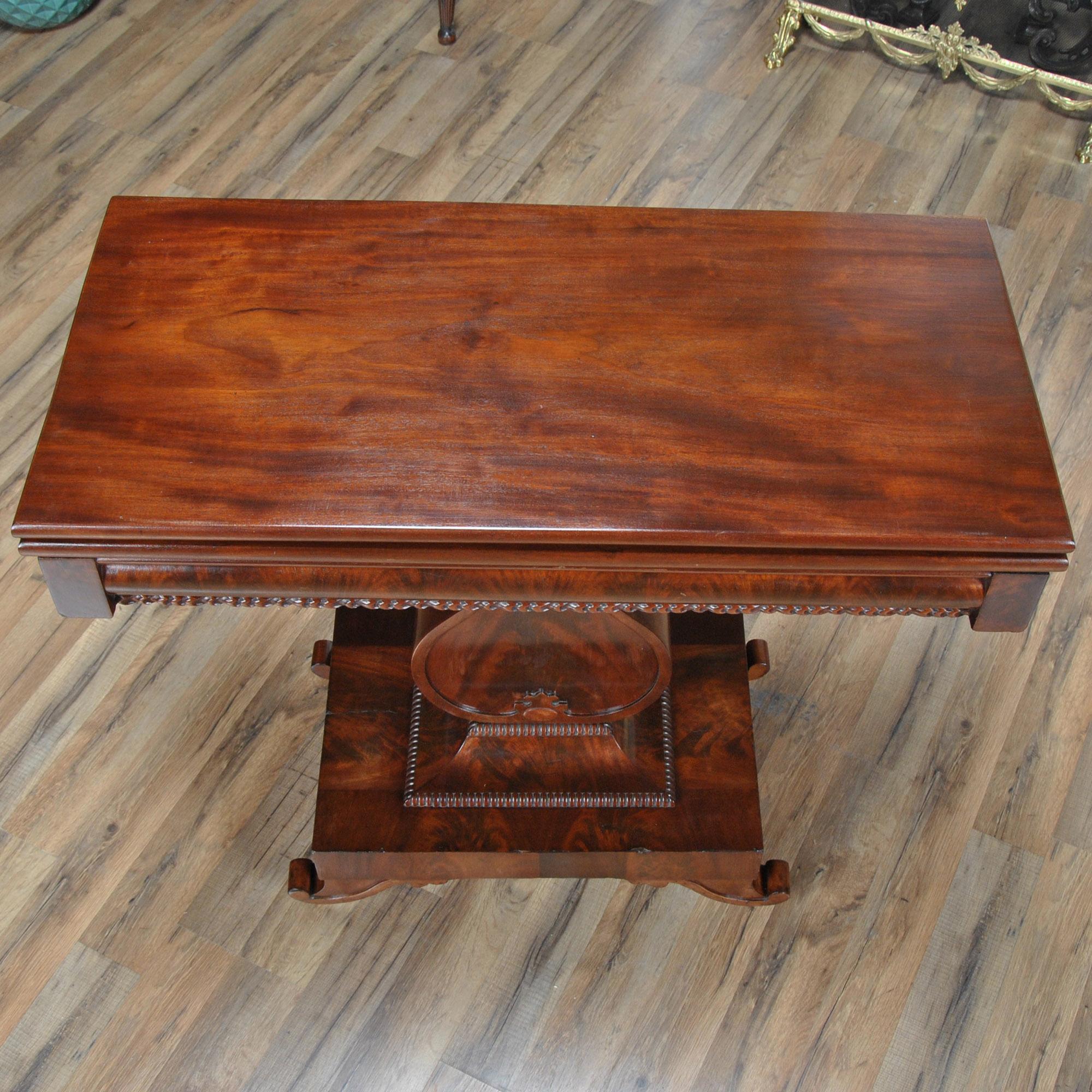 A Vintage Mahogany Neoclassical Game Table. Inspired by a Duncan Phyfe design this high quality game table is both decorative and versatile. The table can be used with the top in the closed position as a hallway or entrance piece, it can also be