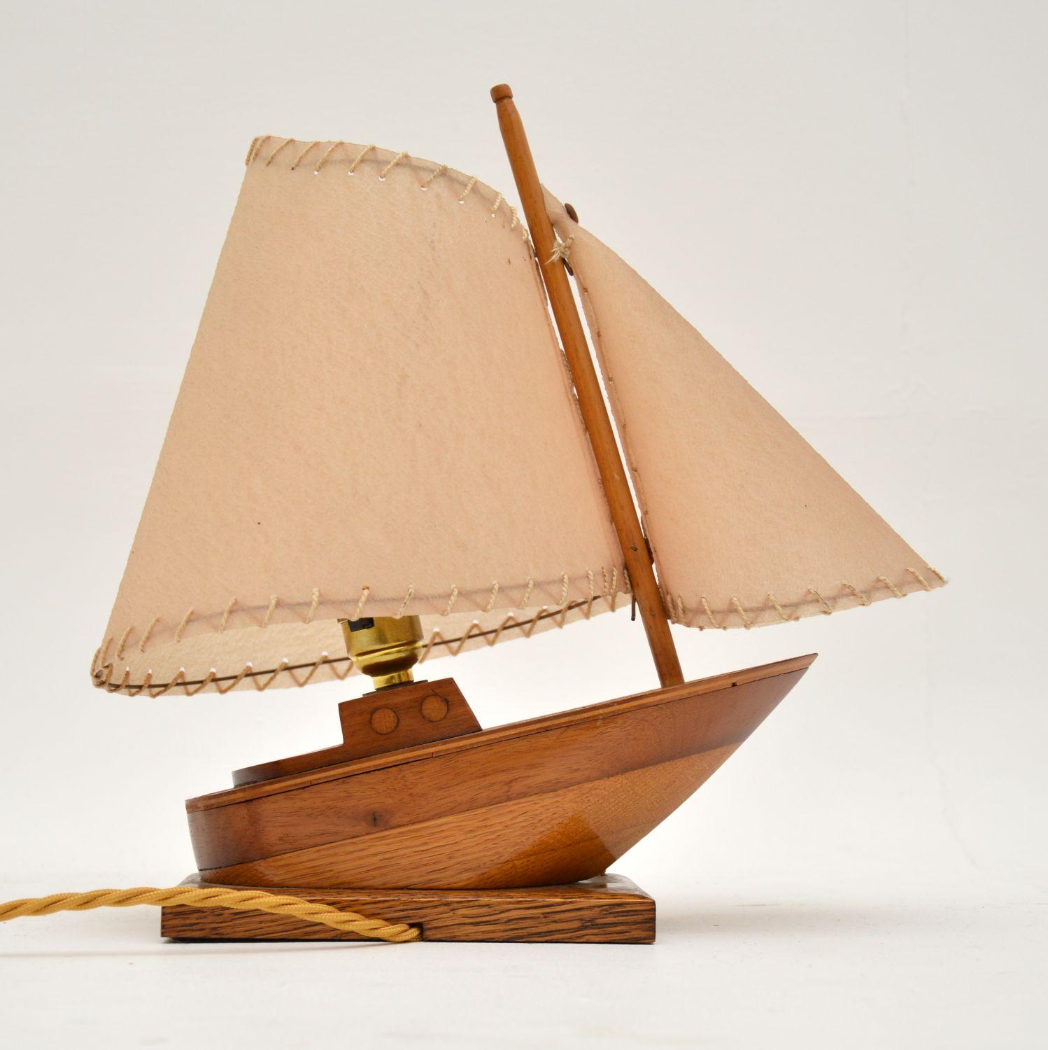 A beautiful and unusual table lamp, crafted in the shape of a sail boat. This dates from the 1960’s.

It is of lovely quality, the boat is really well made from solid oak and mahogany. The shade is shaped like the sail, and is also beautifully