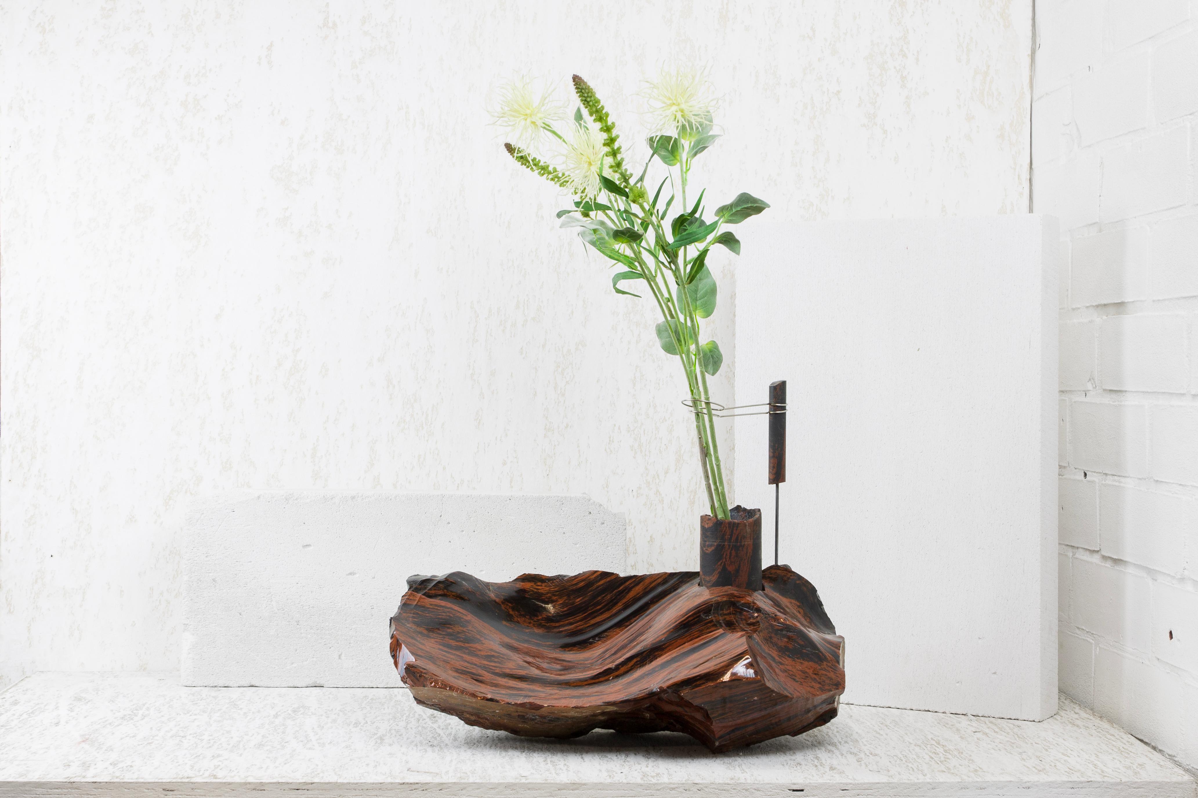 Mahogany Obsidian Flower Vessel by Studio DO
Dimensions: D 50 x W 34 x H 41 cm
Materials: Mahogany Obsidian, stainless steel.
26 kg.

Flowers are intrinsically connected with composition and earth.
Influenced by varied vessels from past to present