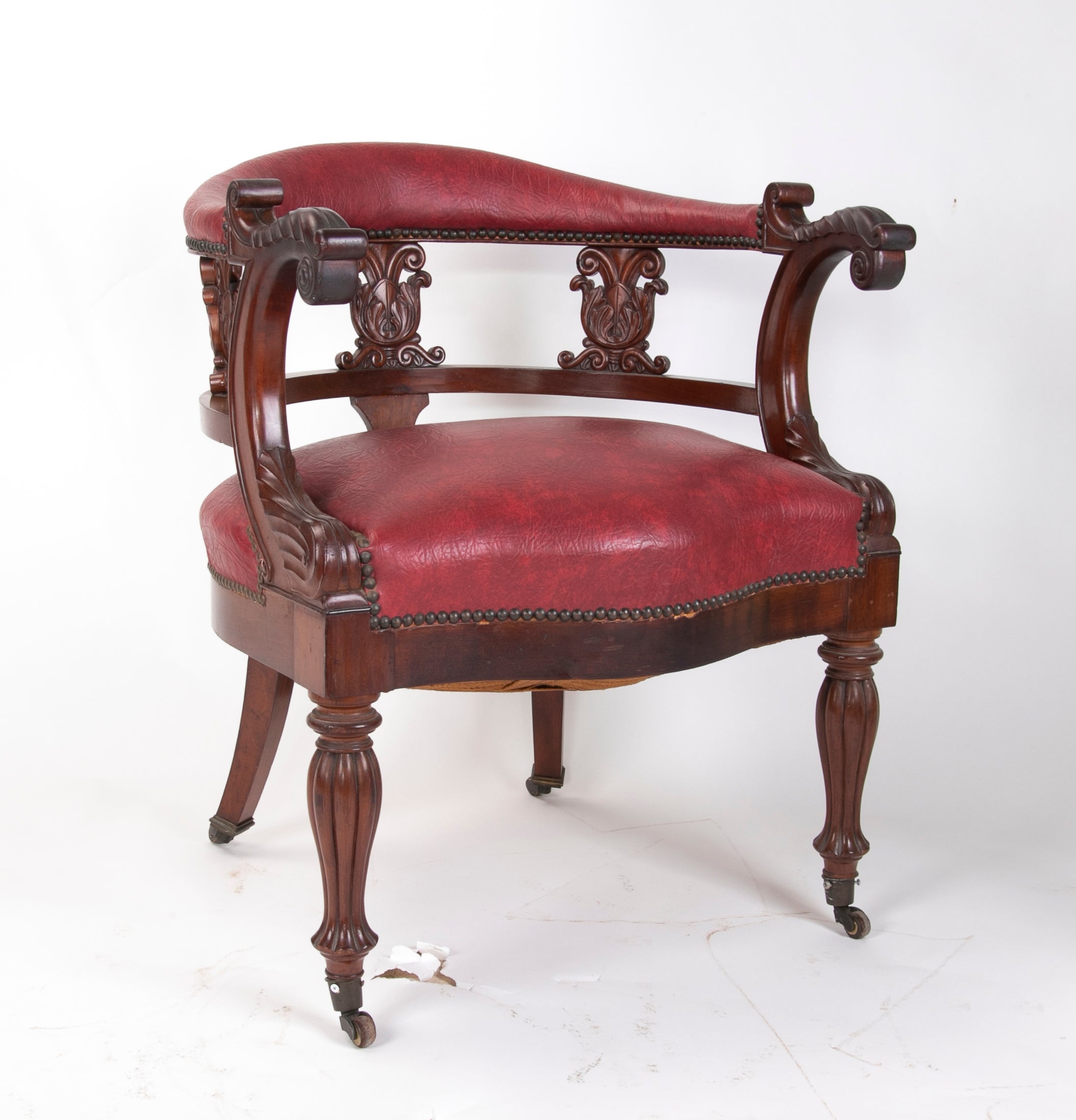 Mahogany office chair with bronze wheels and faux leather seating and backrest.