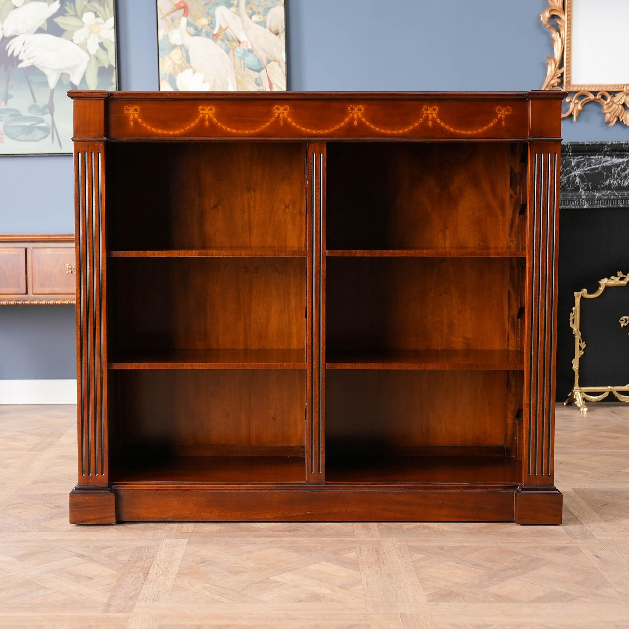 An excellent quality Mahogany Open Bookcase produced by Niagara Furniture. The top section features a moulded cornice with hand cut satinwood inlays arranged in a drape pattern. The open section being divided by a central reeded column for support
