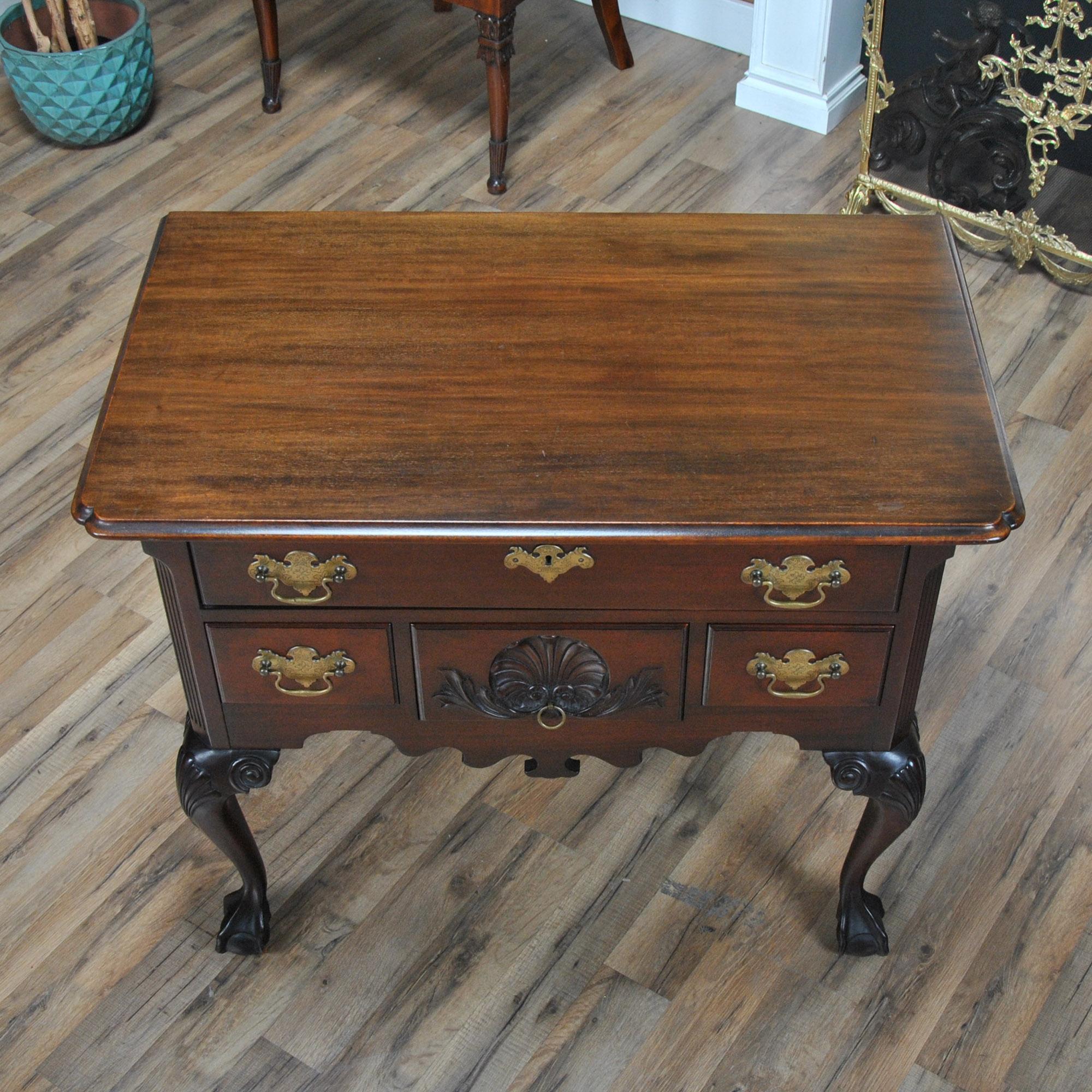 A vintage mahogany Paine chippendale lowboy dresser. This classically shaped chest features four drawers which are each beautifully shaped and carved to work together creating both a functional and attractive overall appearance. Based upon designs