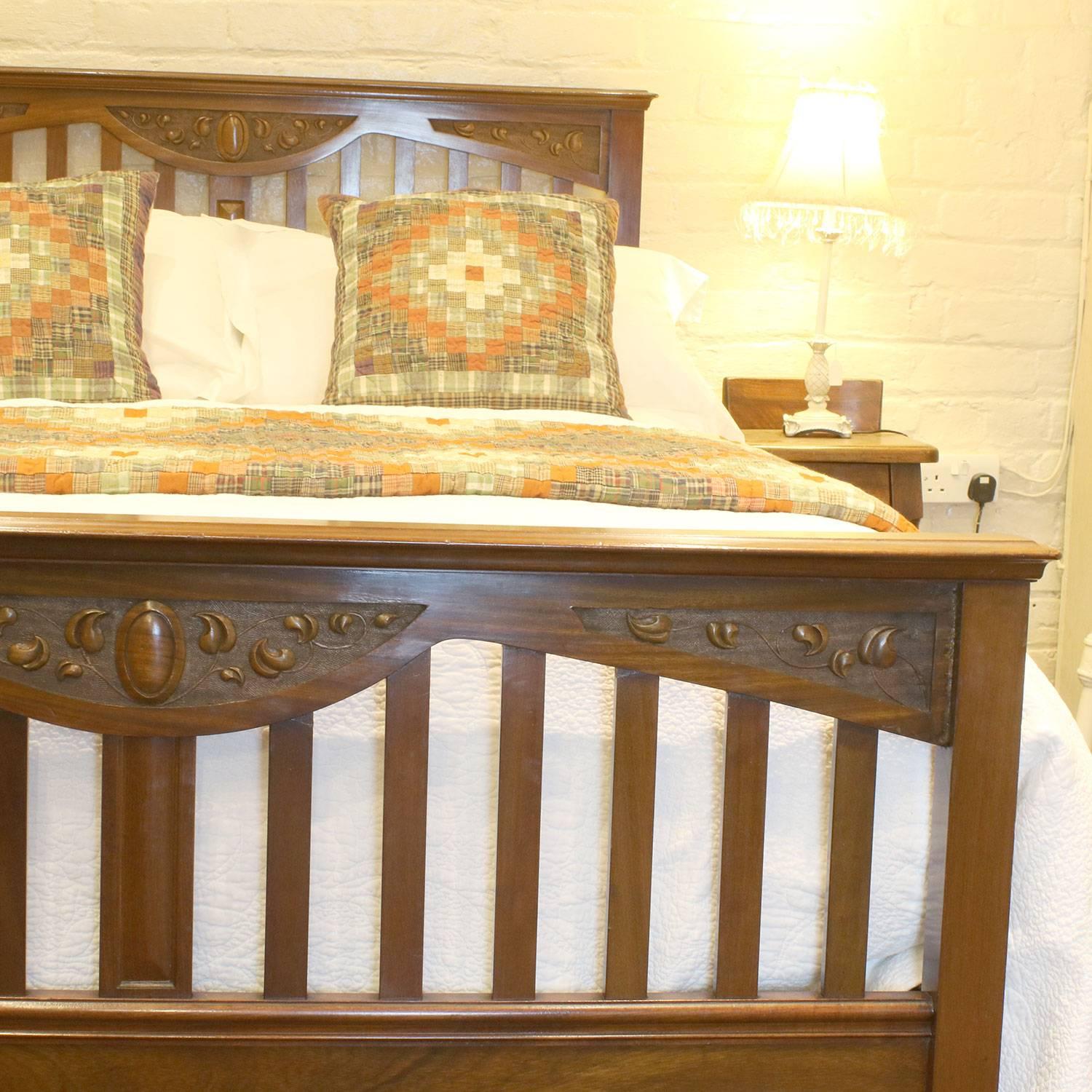 A low mahogany panelled bed.

This bed accepts a double size base and mattress (54 inches, 4ft 6in or 135 cm).

The price is for the bed frame alone - the base, mattress, bedding and linen are extra and can be supplied.