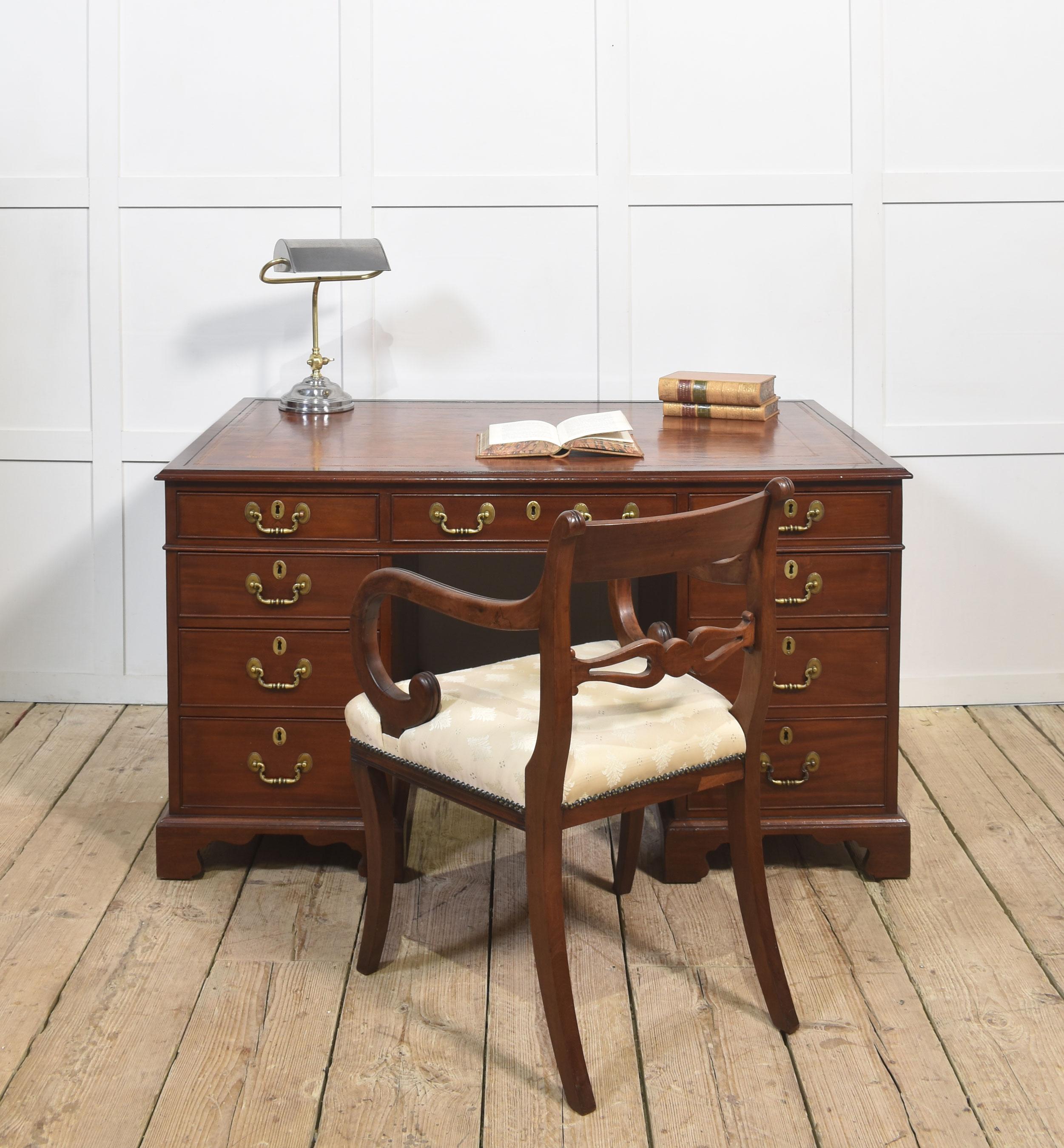 Mahogany partners desk the rectangular top with inset leather having tooled border, enclosed by a moulded edge over an arrangement of three freeze drawers. Above two pedestals, one side with two banks of three drawers, the opposing side fitted with