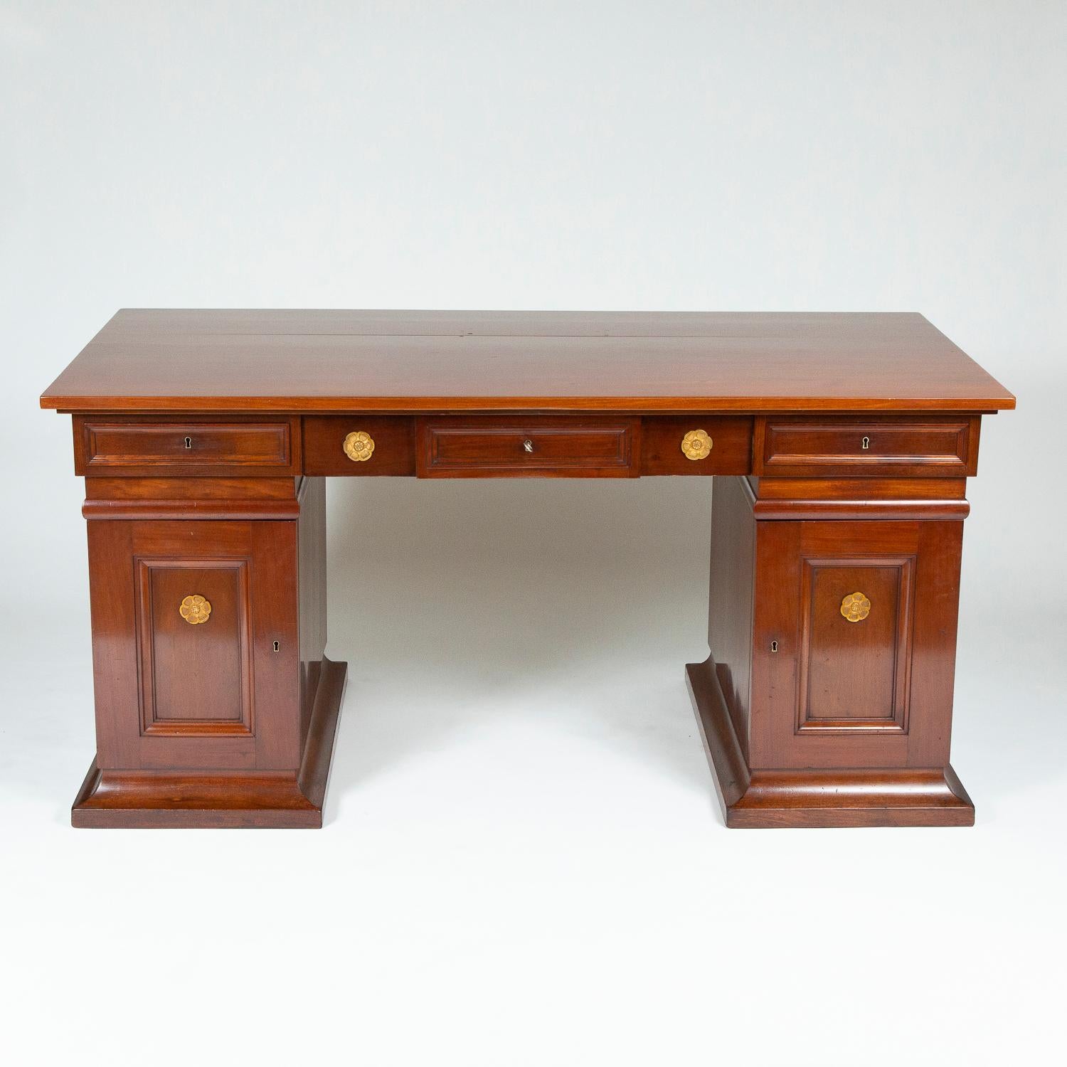 A mahogany pedestal desk with gilt bronze mounts, designed by Thorvald Bindesbøll, made by Severin and Andreas Jensen of Copenhagen. 

Thorvald Bindesbøll (21 July 1846-27 August 1908) was a Danish National romantic architect, sculptor and