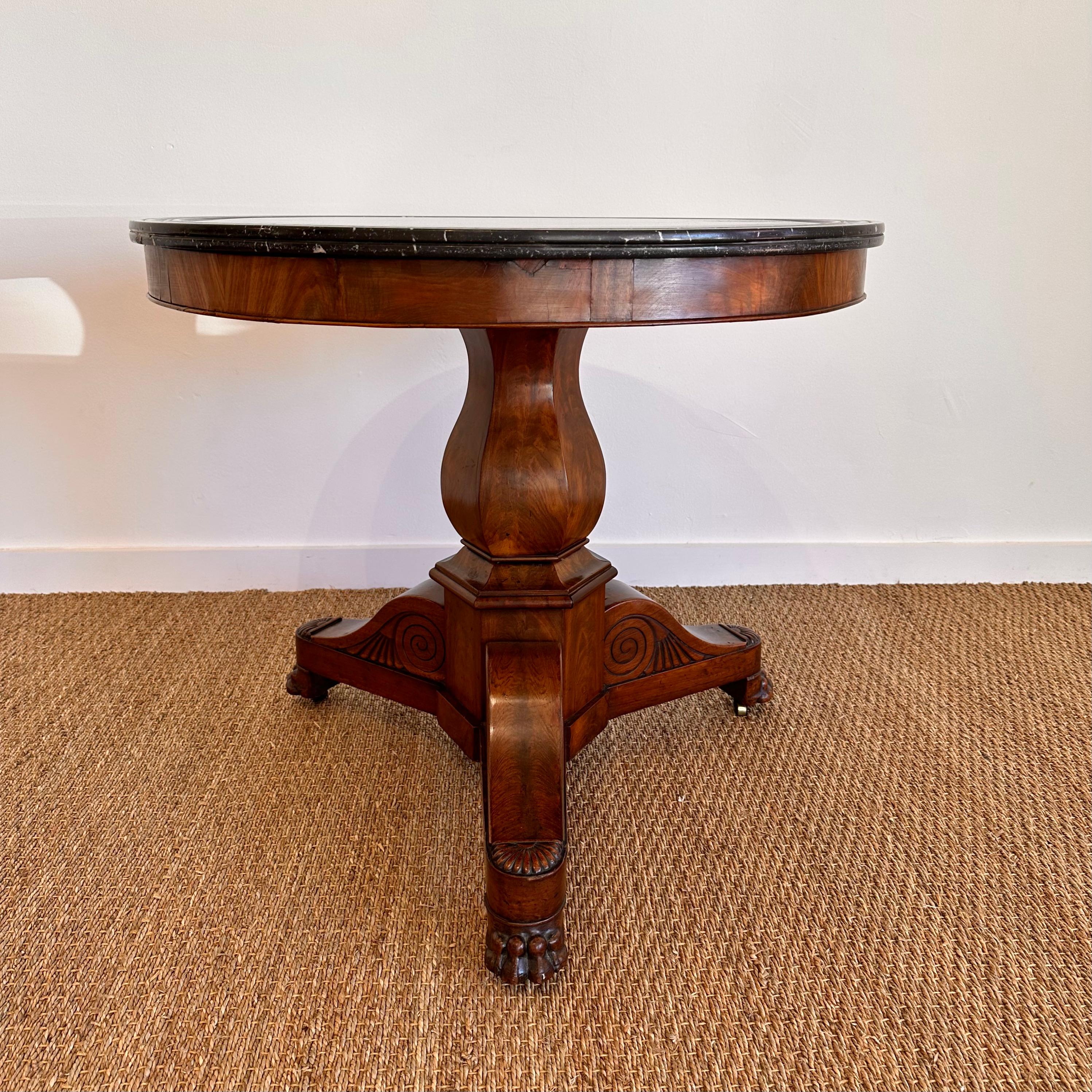 Charles X Period Mahogany and Marble center table.   Carved tripod base with urn shaped pedestal. Beautiful silhouette.  