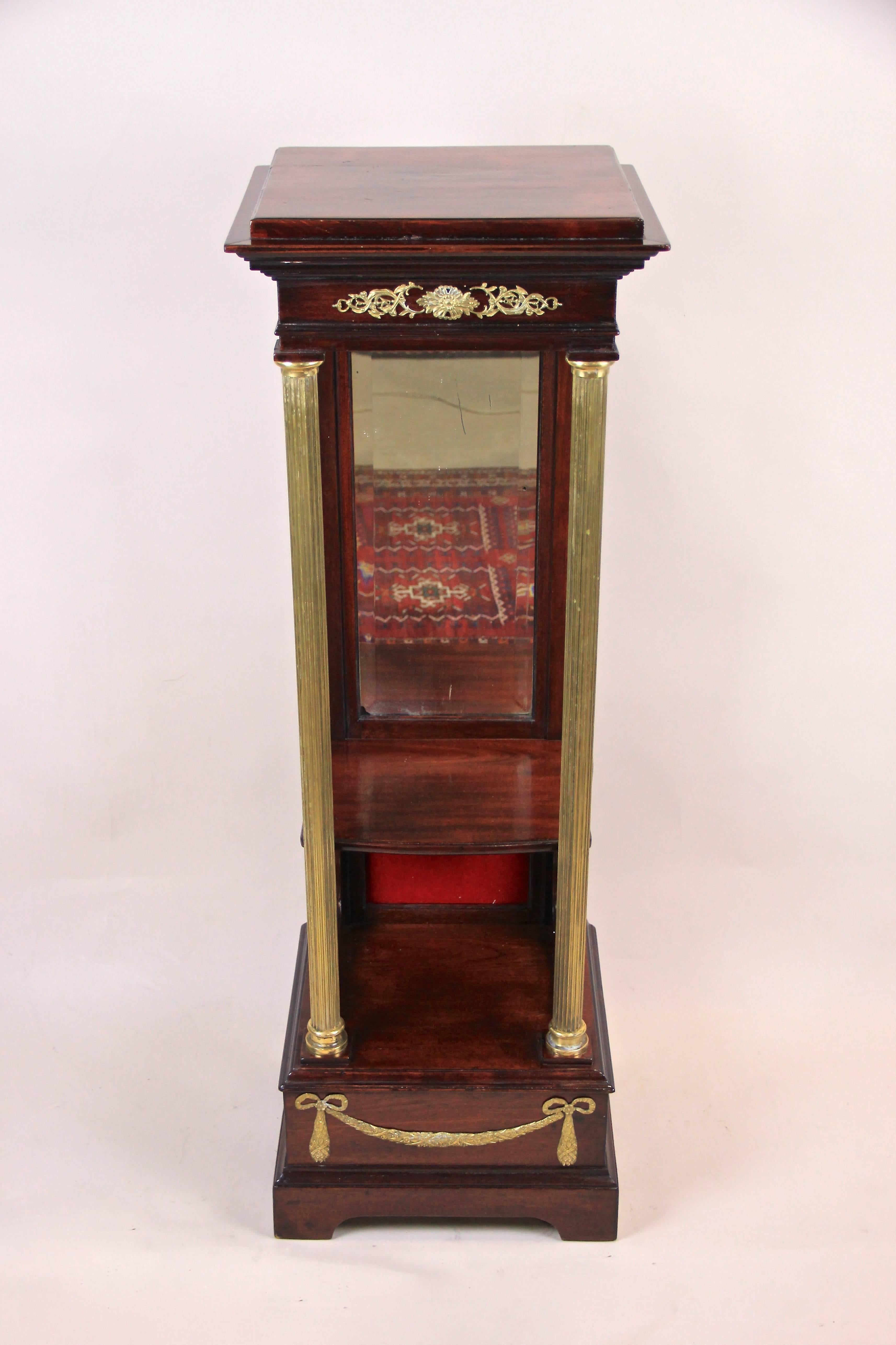 Gorgeous mahogany pedestal with mirror from the Napoleon III period in France, circa 1880. Veneered in fine mahogany this console pedestal impresses with a great design and beautiful details like the brass columns or lovely applications on the front