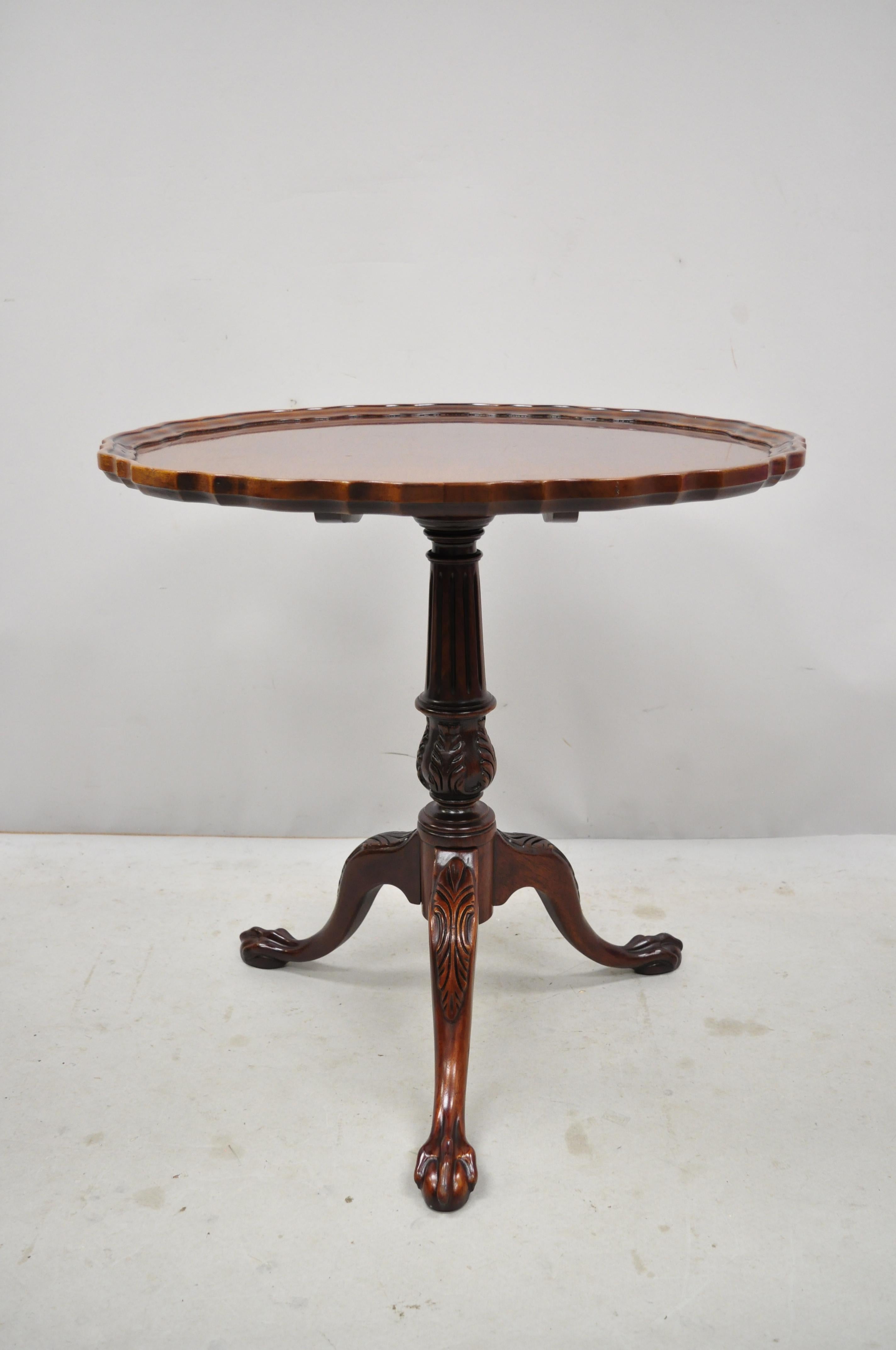 Mahogany Pie Crust Ball and Claw Georgian Chippendale Style tilt-top  Tea Table. Item includes a solid wood construction, beautiful wood grain, nicely carved details, carved ball and claw feet, solid brass hardware, very nice vintage item, quality