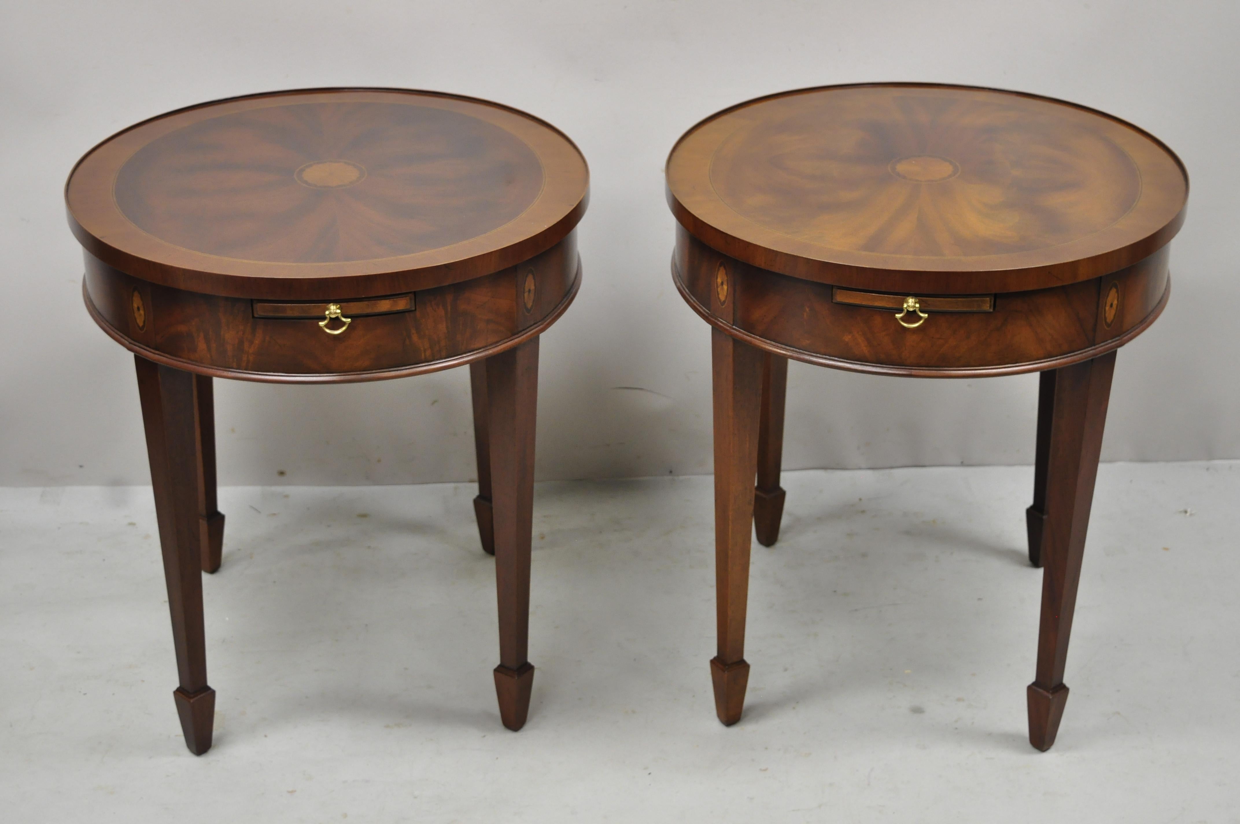 Vintage mahogany pinwheel inlay oval Federal lamp end table with pull out surface - a pair. Item features pull out surfaces, pinwheel inlay top and skirt, beautiful wood grain, quality American craftsmanship, great style and form. Circa mid to late