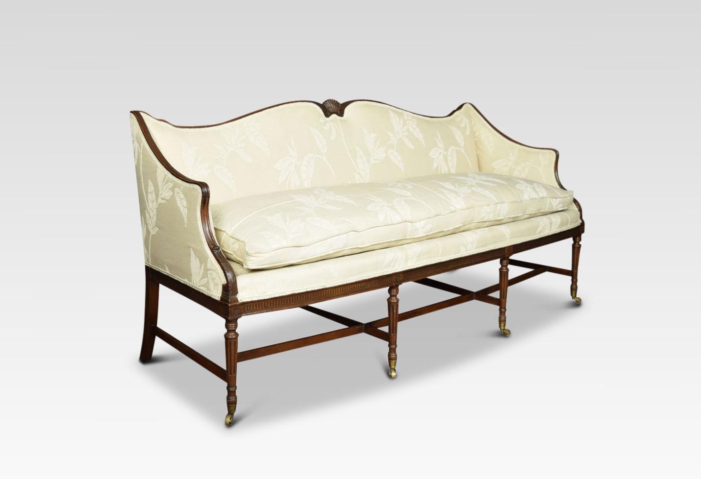 Early 20th century mahogany Regency style three-seat settee, the shaped back with central carved fan, above back seat and arms upholstered in serviceable cream chenille fabric with removable cushion All raised up on fluted front legs terminating in