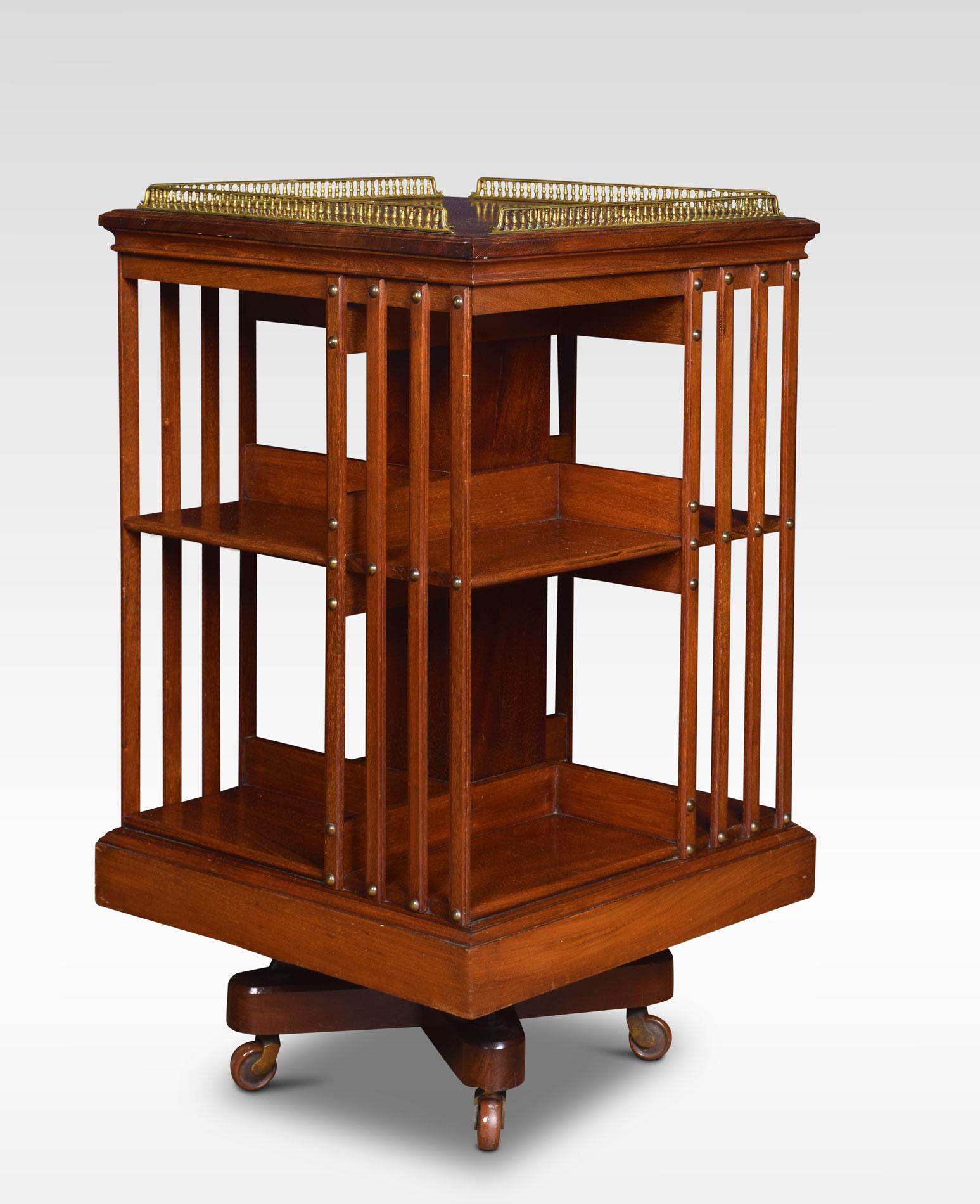 Mahogany revolving bookcase the unusual raised brass gallery top above an arrangement off shelves raised up on a cruciform metal base with castors by Maple & Co.
Dimensions:
Height 35 inches
Width 20 inches
Depth 20 inches.