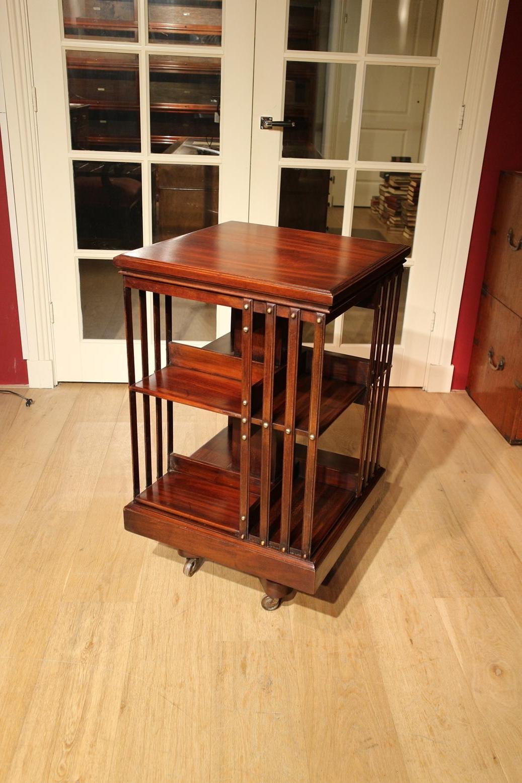 Beautiful mahogany revolving bookcase in good condition. It is a very solid revolving bookcase with a cast iron base. Made around 1900 by the firm Maple & Co. Size: 49cm x 49cm x H 86cm The maker Maple & Co was by the end of the Victorian period