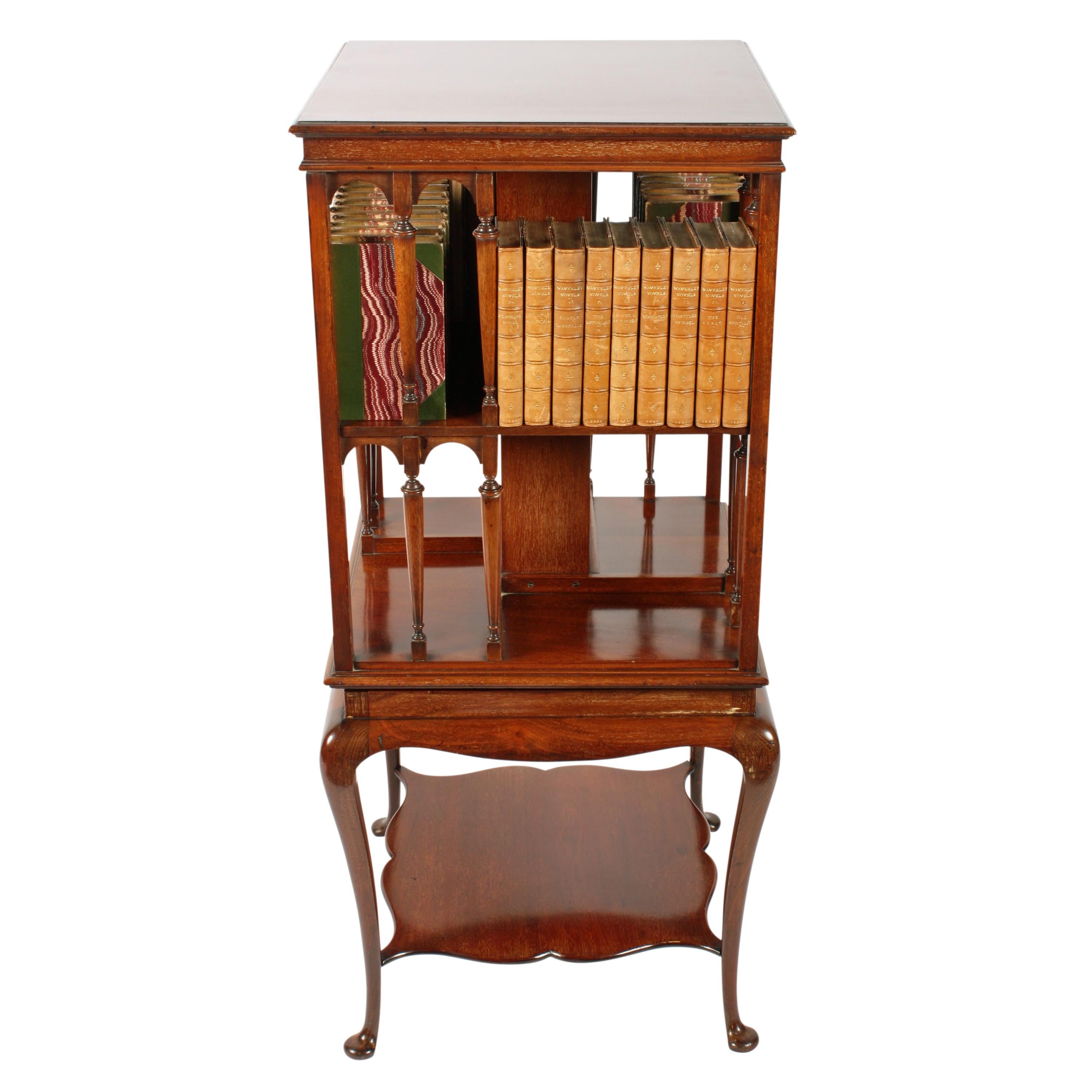 Mahogany revolving bookstand


A late 19th to early 20th century mahogany revolving bookstand on a cabriole legged base.


The solid mahogany bookcase top has two levels of book racks which have decorative turned pillars to the sides.


The