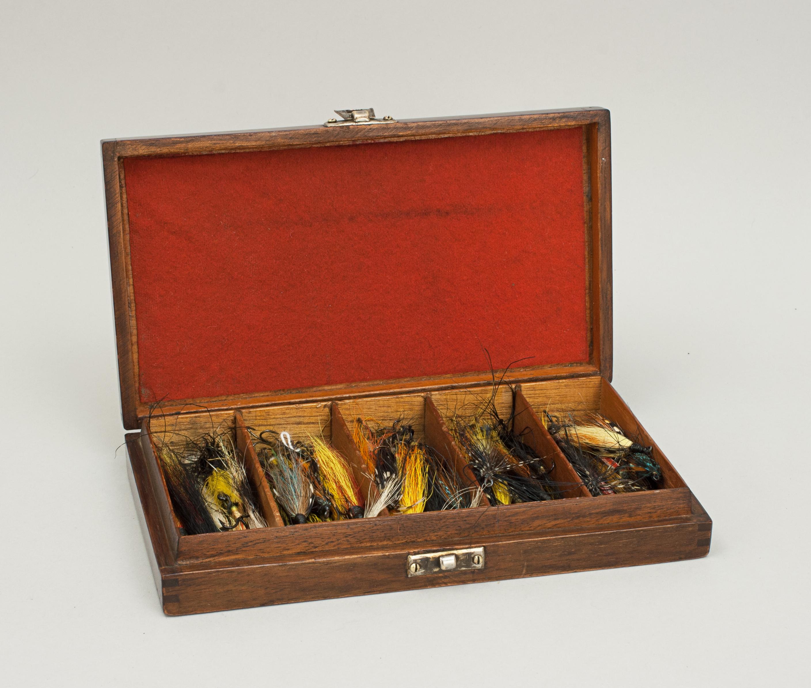 Wooden fly box, Hardy Bros.
A very nice mahogany fly box with five compartments full of dressed salmon flies. The lid has a nickel 'Hardy Bros. Ltd.' oval badge pinned on the outside, on the interior there is some red baize.