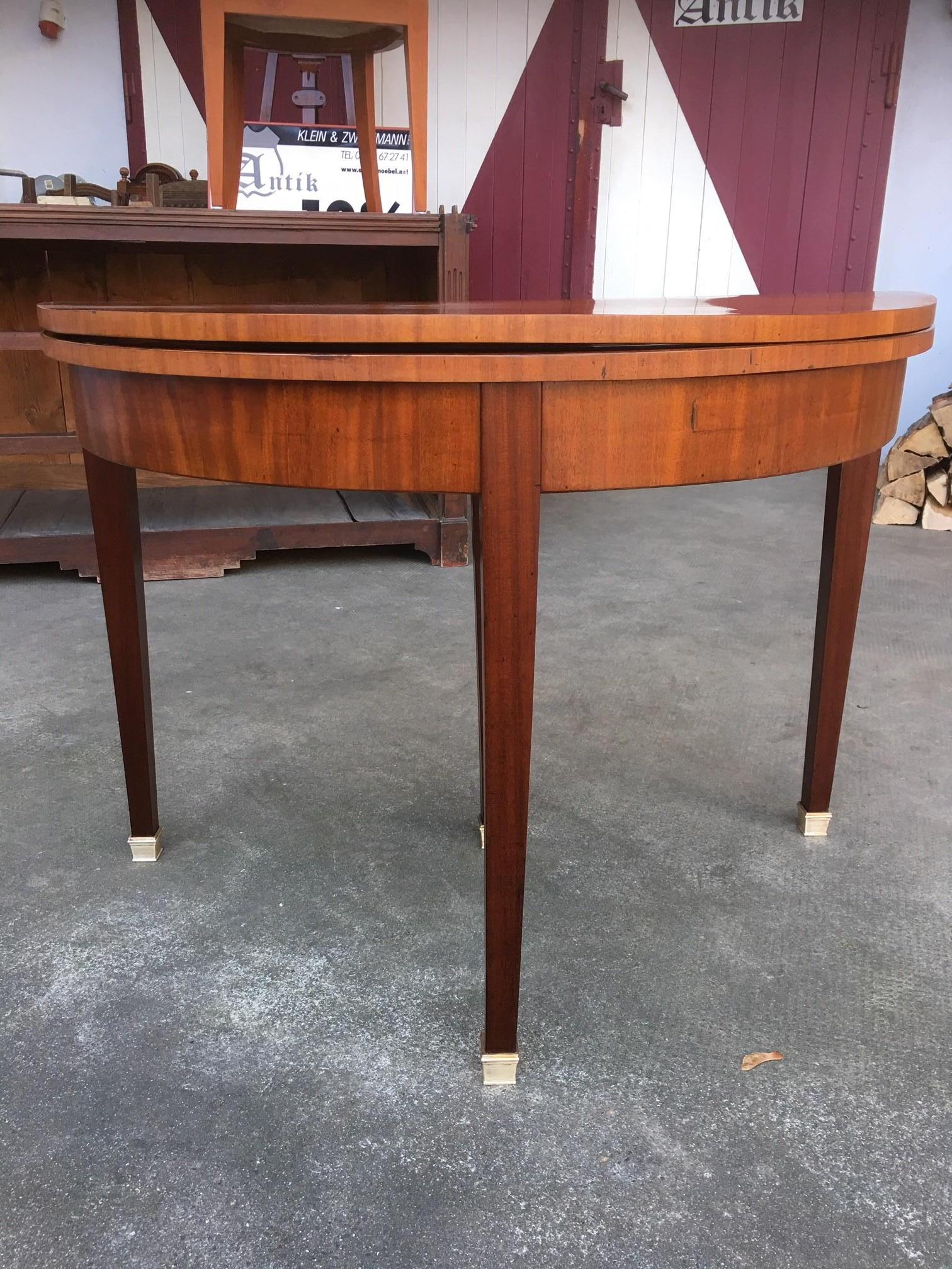 This is an Empire salon table with beautiful inlays and finest brass applications. The palisander and walnut precious woods were hand polished with shellac and brought to high gloss. This piece shines with a very unique pattern and decorations that