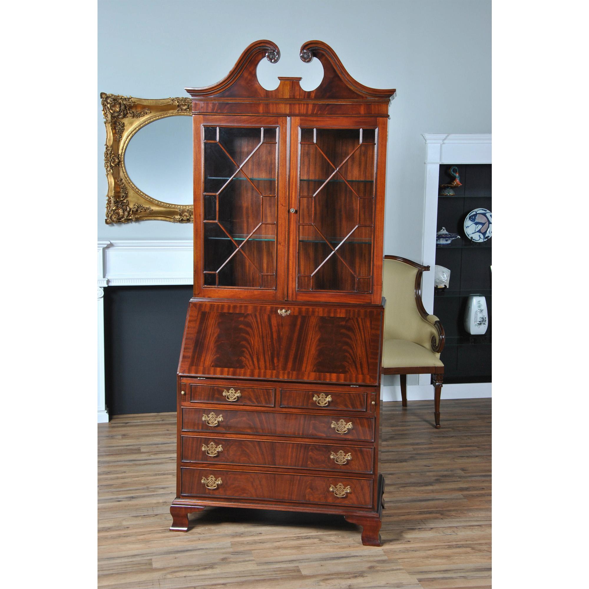 The Mahogany Secretary Desk from Niagara Furniture. This reproduction slant front writing desk has all the outstanding qualities of an antique original. Made of select mahogany solids and veneers the bookcase has a lovely hand carved swan neck,