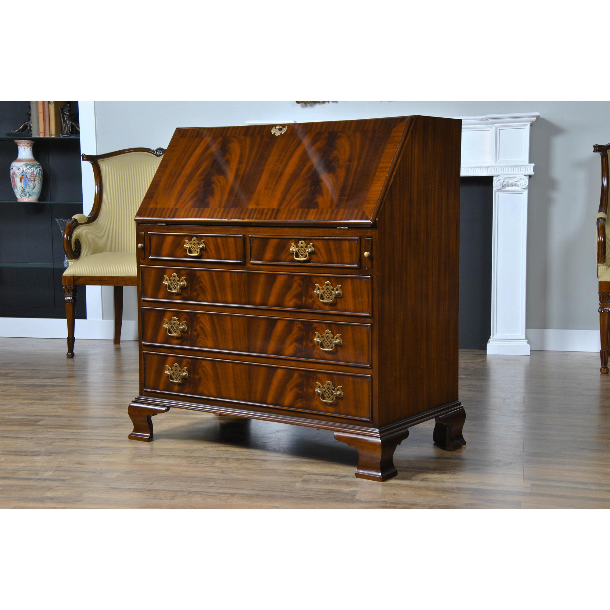 This Mahogany Secretary Desk  from Niagara Furniture has all the outstanding qualities of an antique original. Made of select mahogany solids and mahogany veneers, the desk has four graduated drawers resting over top of shaped, ogee bracket feet.