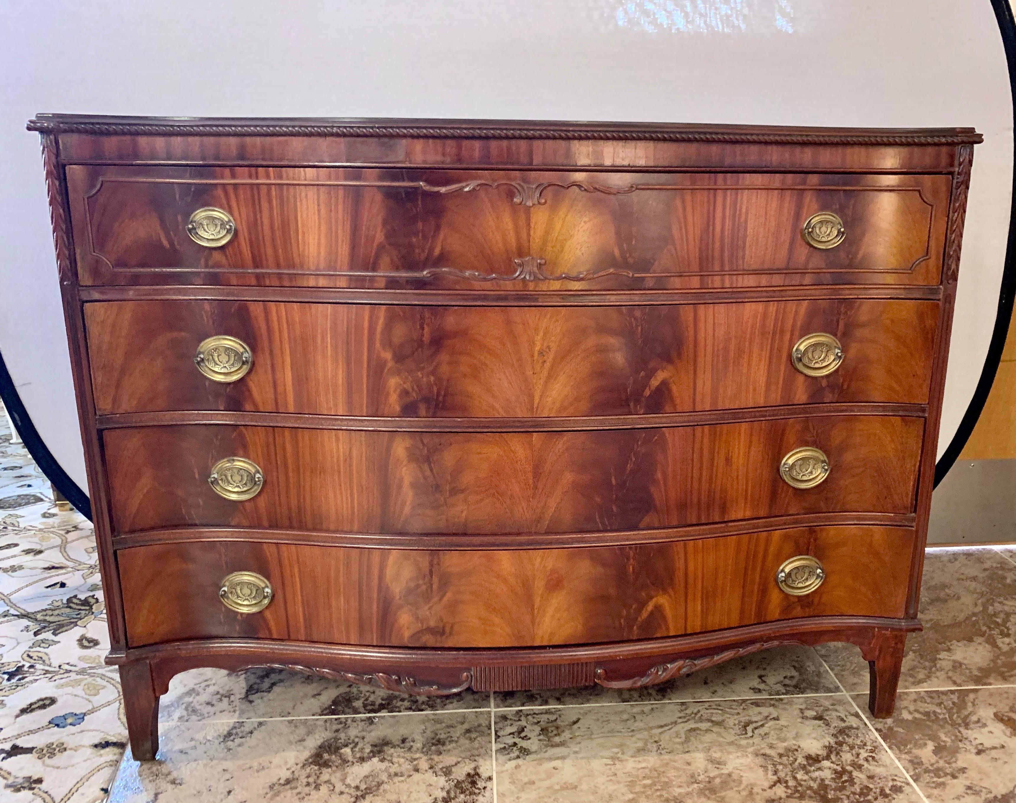 Elegant early 20th century flame mahogany serpentine commode with original brass hardware and four dovetailed drawers. Great lines and better scale.
Now, more than ever, home is where the heart is.