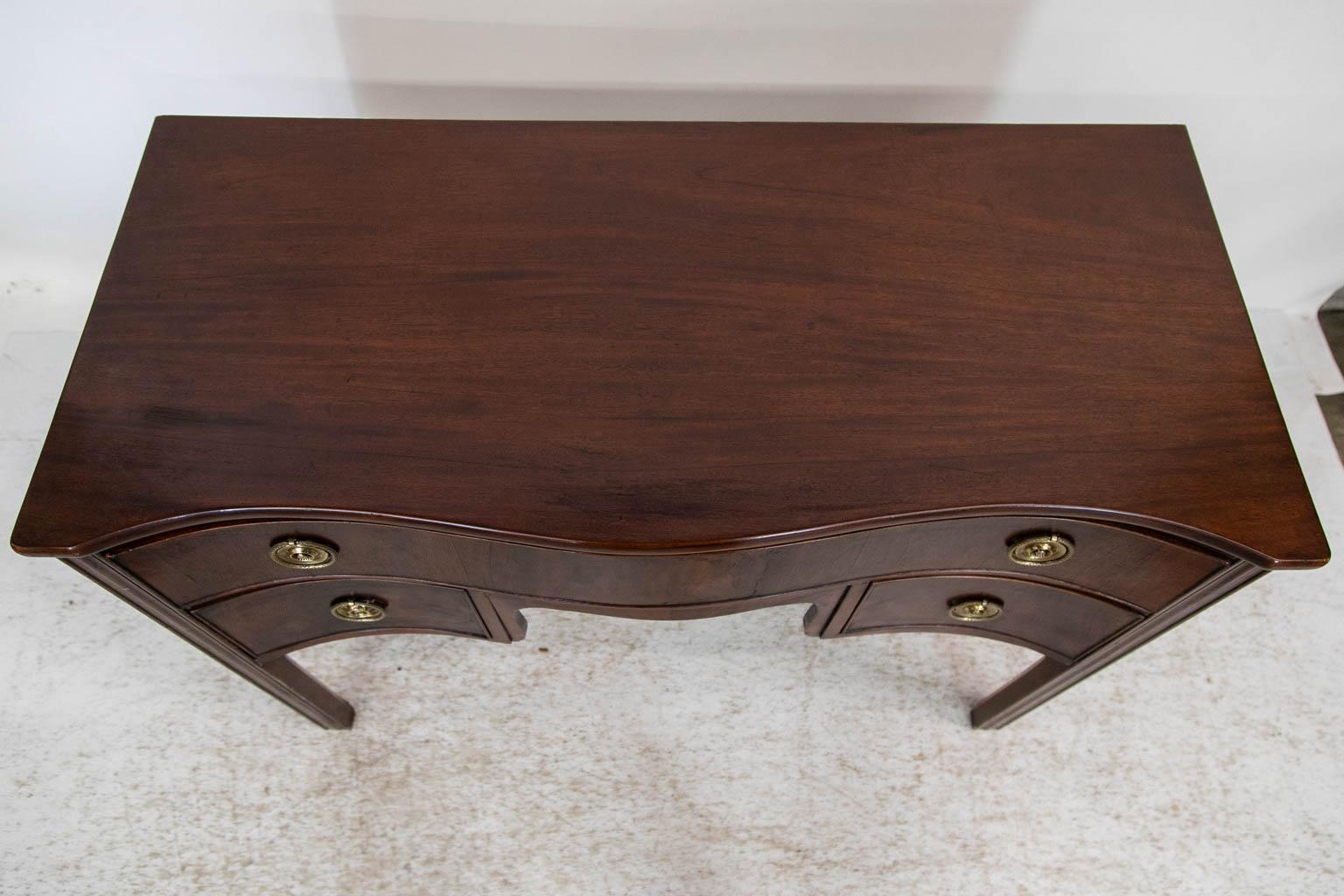 The legs of this server have carved shaping on the front and sides. The center apron has bookmatched veneers. The sides are plum pudding mahogany.