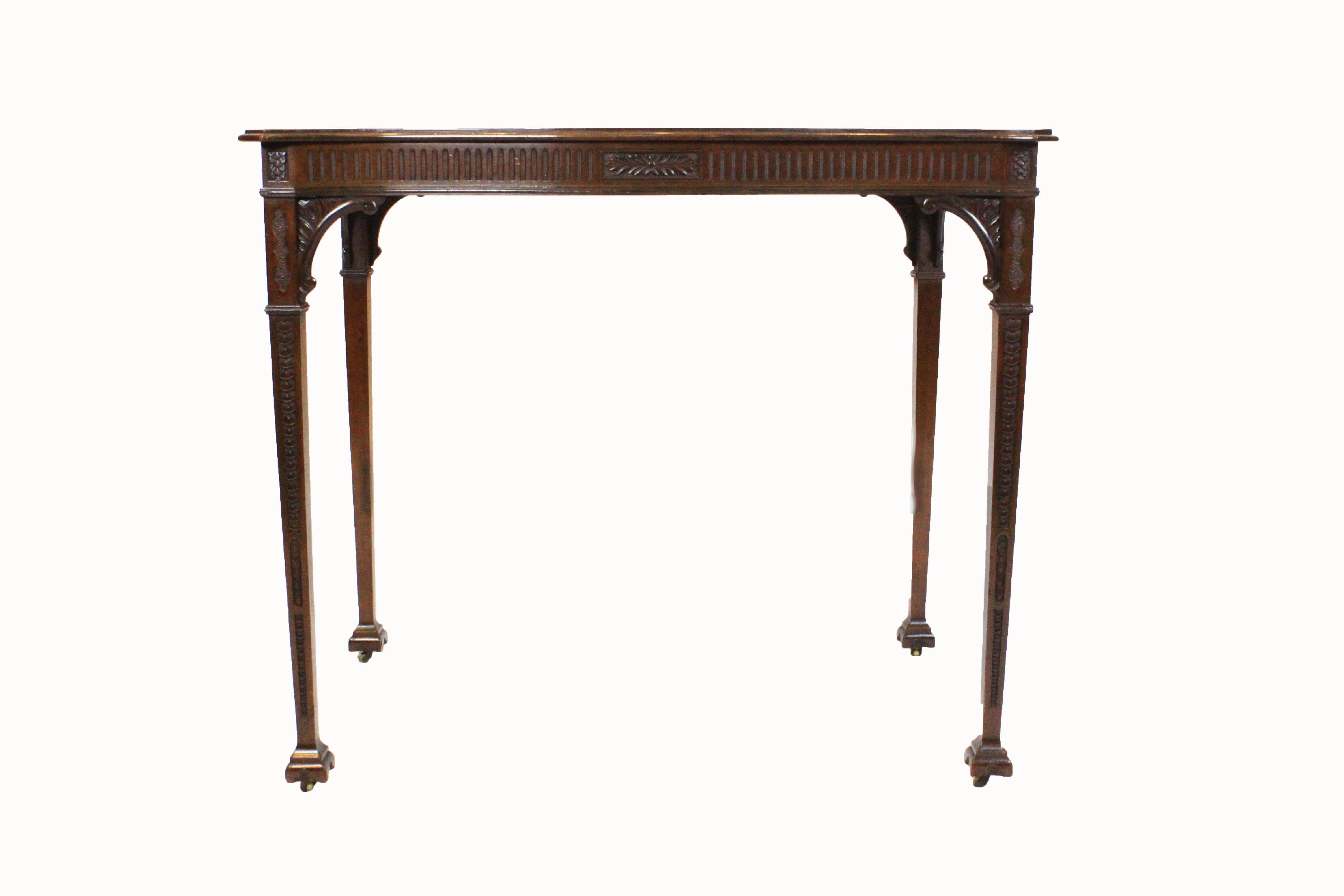 Serpentine silver table of Adam influence with solid mahogany figured top with lipped and moulded edge over fluted and carved frieze having a central carved rosette. Standing on finely carved, tapered legs with acanthus leaf carved corner brackets