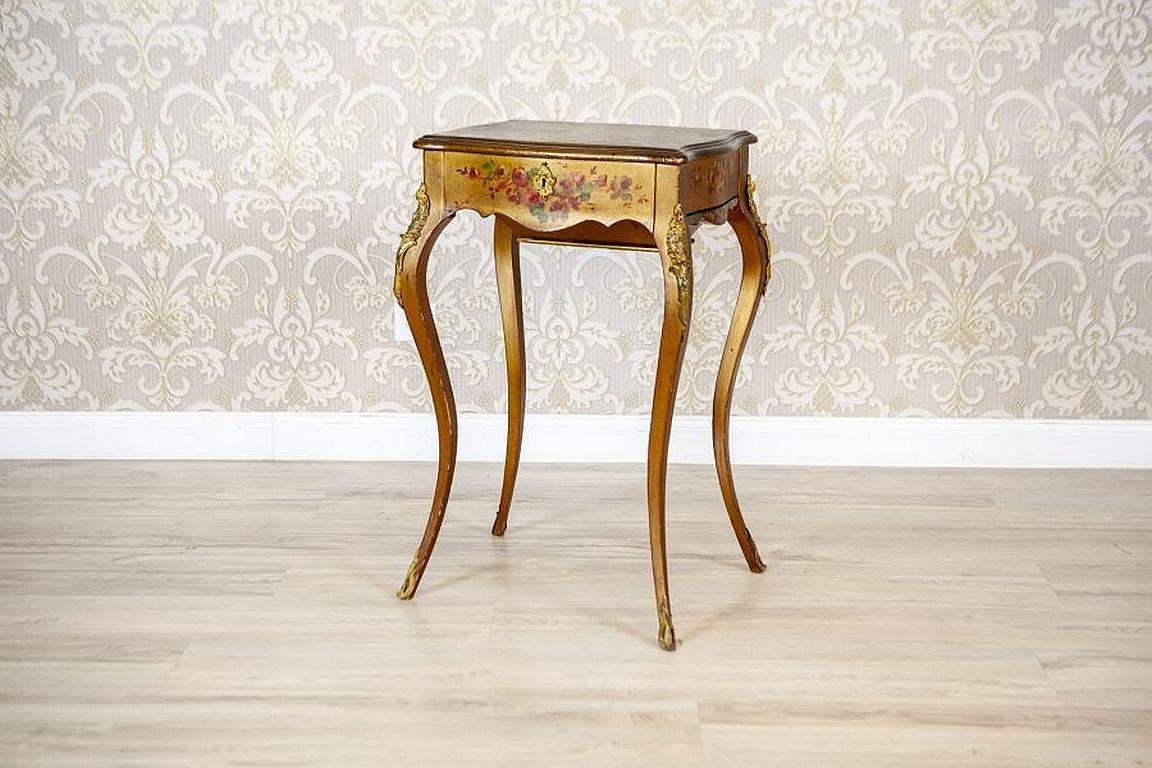 Mahogany Sewing Table with Brass Details from the Late 19th Century

We present you a neat sewing table. This piece of furniture is placed on bent cabriole legs with brass appliqués. The top is liftable, with a profiled edge. Under the apron, there