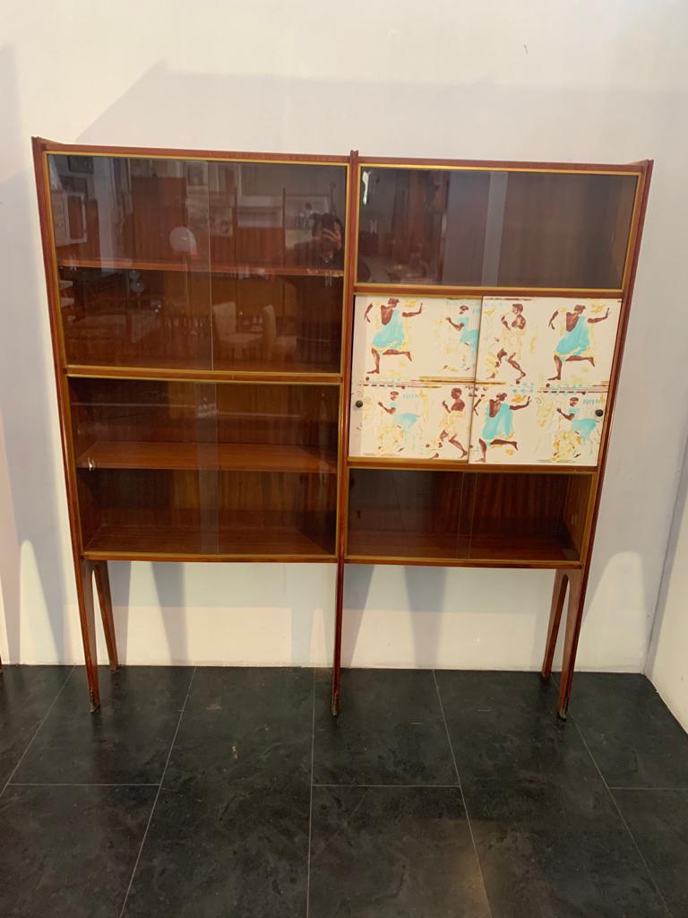 Showcase bookcase 1 of 2 left and right in blond mahogany 50s bronze tips The guides of the sliding glasses are in brass, have 2 doors with greek classicism decoration. The style, design, decorative panels, reconnect to Osvaldo Borsani.
