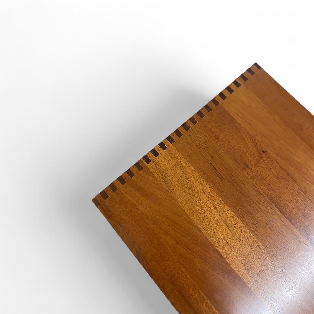 Solid mahogany shelving designed by Christian Hvidt and edited by Søborg Møbler in the 1970s. The design is sober and functional, highlighting the natural beauty of the wood, the precision of the assemblies and the exceptional quality of