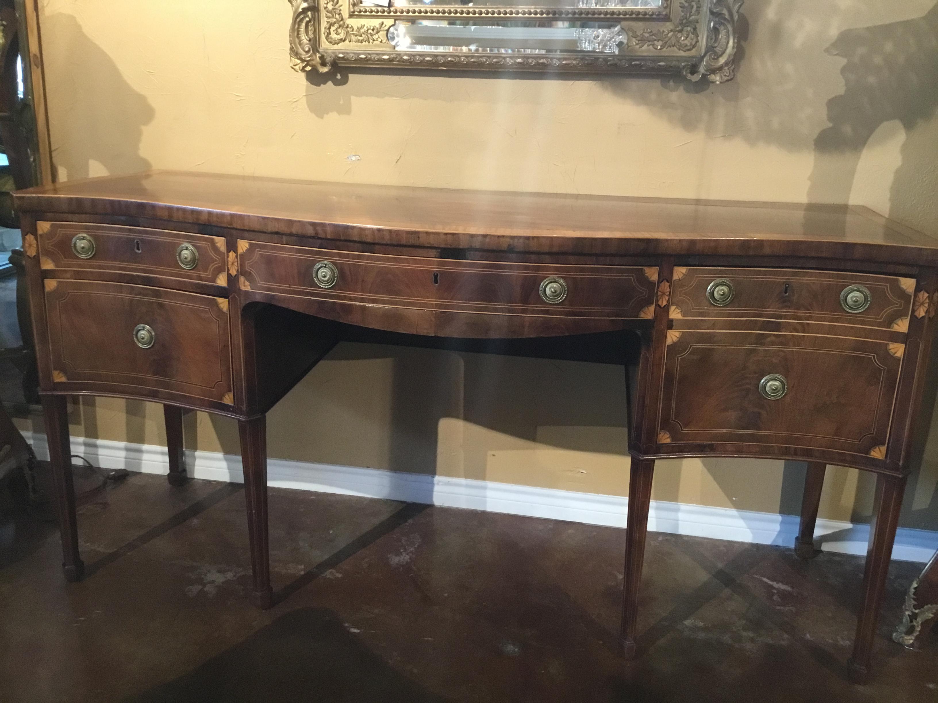 Credenza del XVIII secolo con finitura originale e piano a fasce in legno di raso
Intarsi. Il frontale a forma di serpentina è dotato di cassetti e armadietti.
Con tiretti ad anello in ottone che poggiano su gambe quadrate e affusolate, 1790 circa.