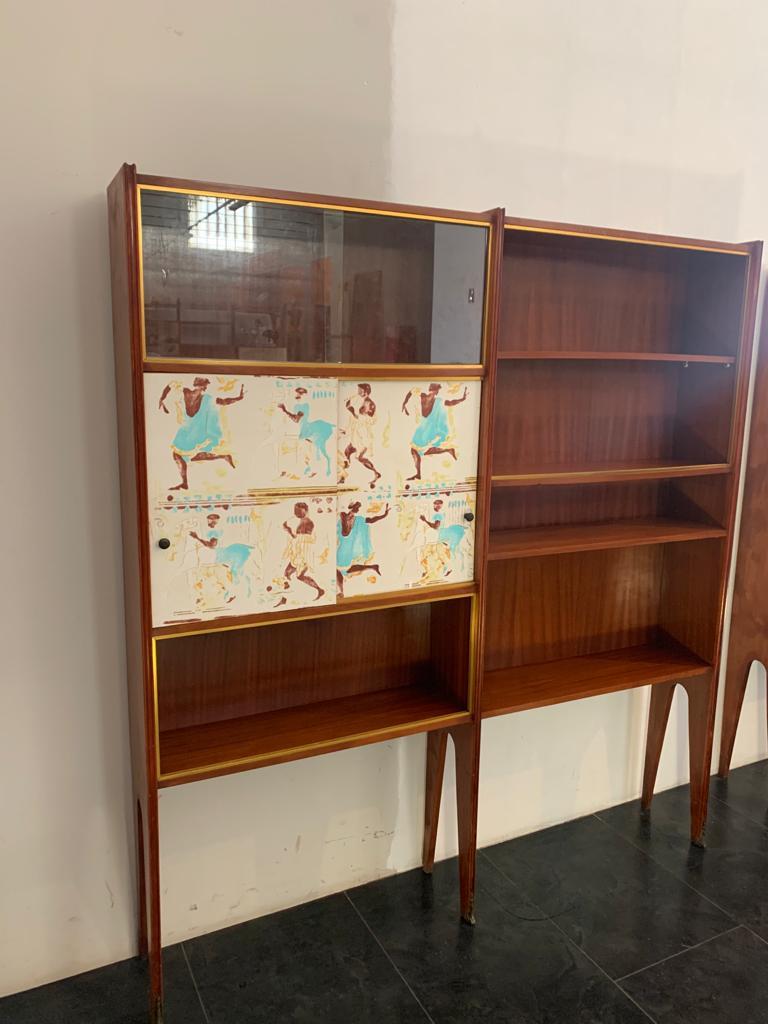 Showcase bookcase 1 of 2 left and right in blond mahogany 50s bronze tips The guides of the sliding glasses are in brass, have 2 doors with greek classicism decoration. The style, design, decorative panels, reconnect to Osvaldo Borsani