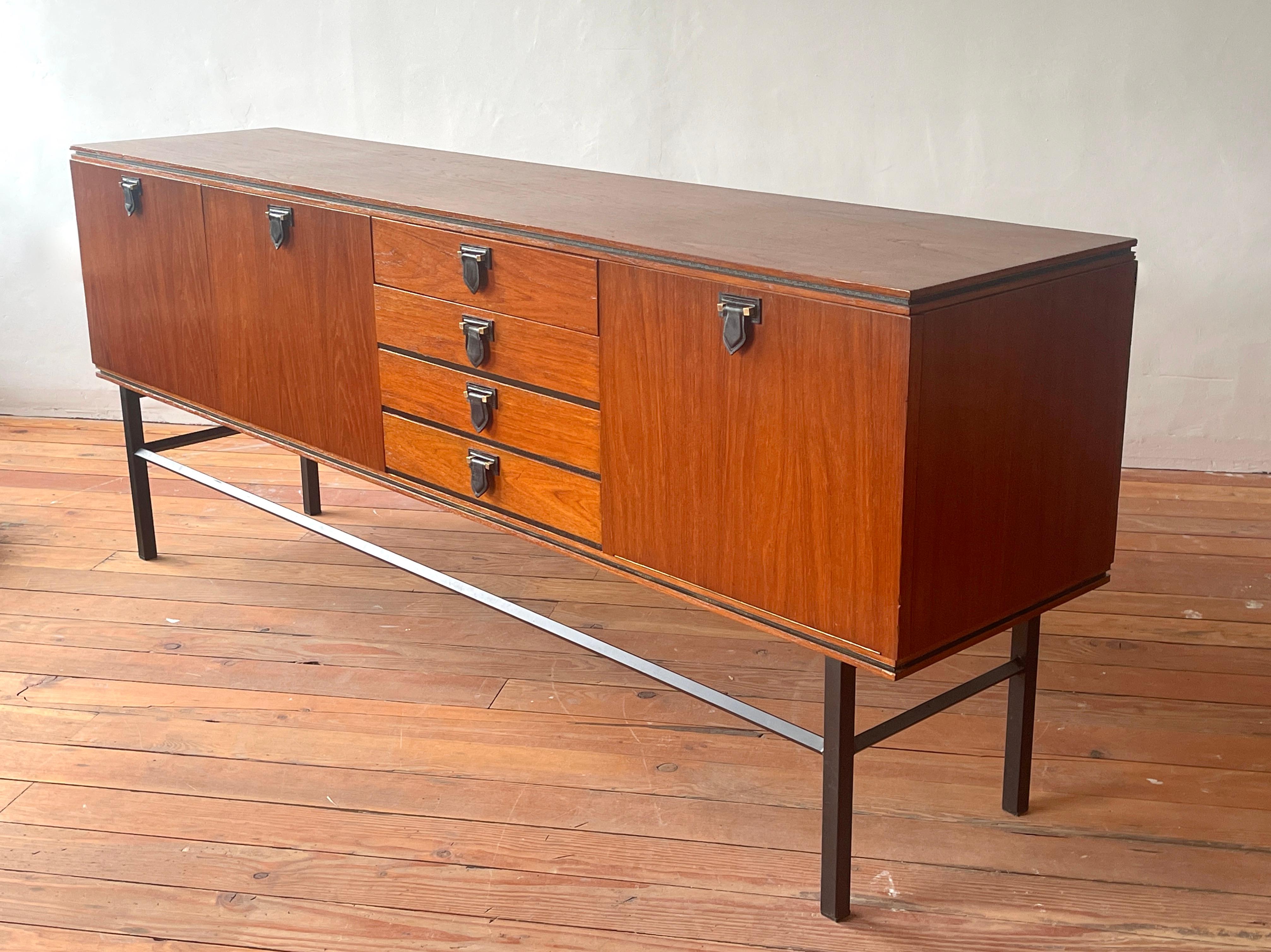 Fantastic European mahogany sideboard with individual black leather handles. 
Handsome and extremely well made - large scale. 
Row of center drawers and open storage with shelving on both sides. 
Black black iron base. 
