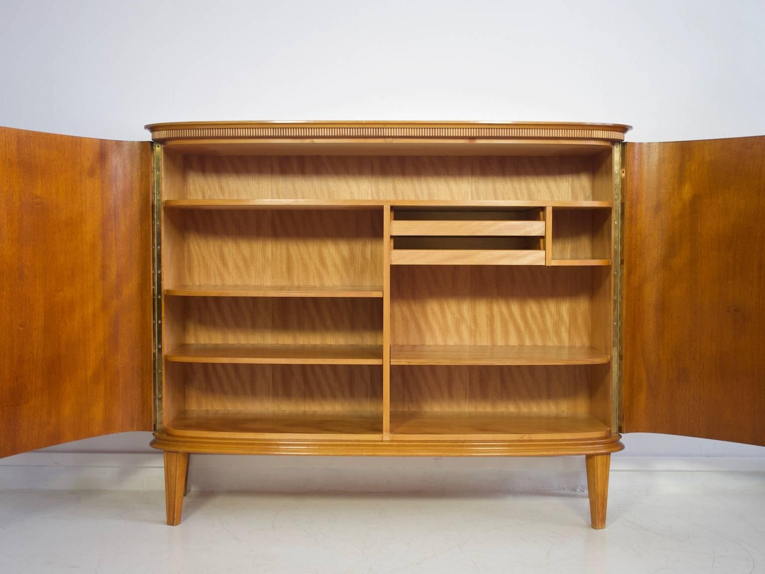 Sideboard or buffet cabinet by AB Seffle Möbelfabrik, Sweden, circa 1940s. Veneered with mahogany. Slightly curved doors behind which are shelves and trays. Labelled by manufacturer, key available.