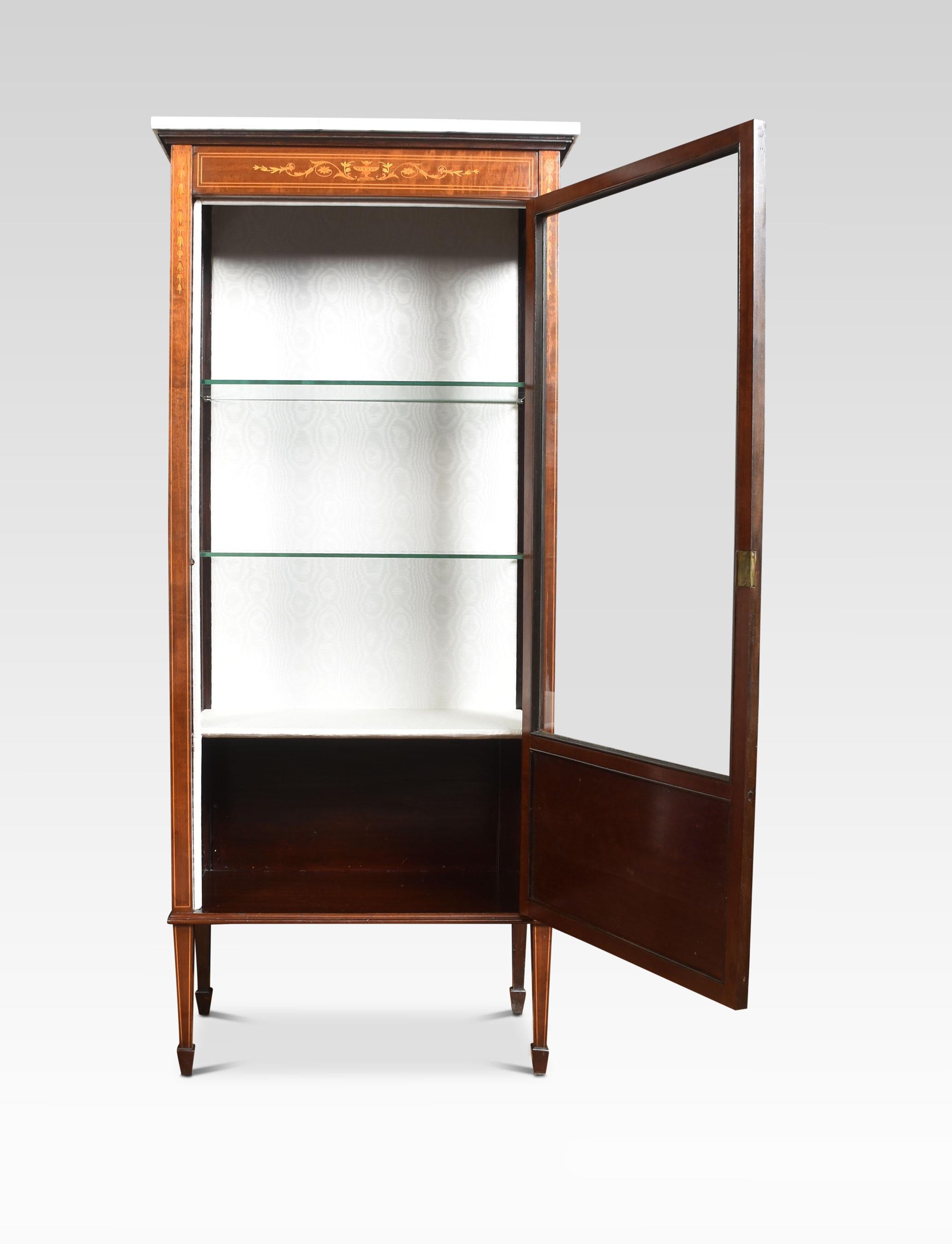 Mahogany inlaid display cabinet, the rectangular white veined marble top above the large single glazed door with inlaid panel below. opening to reveal an upholstered interior with two glazed shelves. All raised up on square section tapering legs