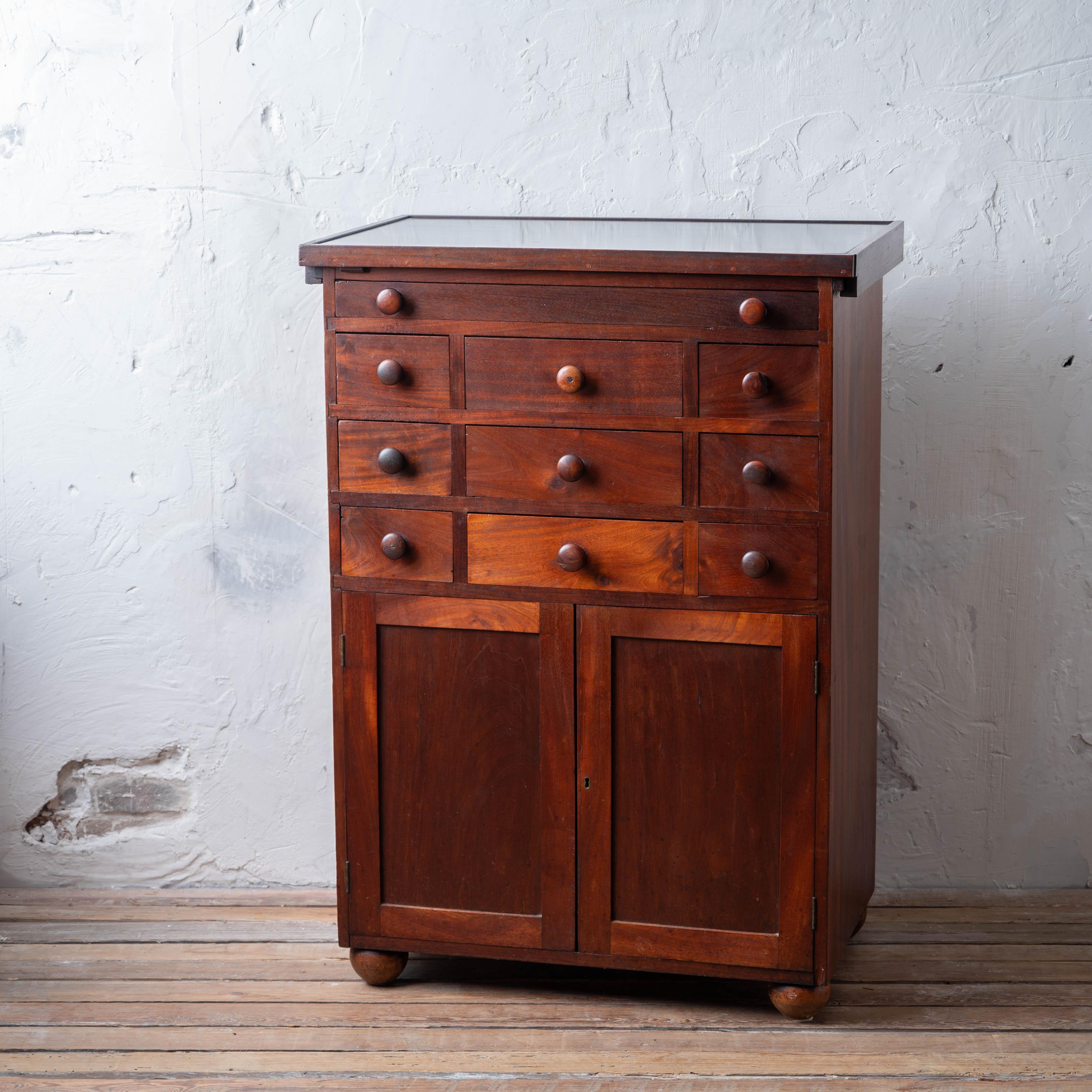 A mahogany apothecary or dental cabinet with slate top, 19th century. 

The top slides forward and can be removed.  The slate is polished on top and the underside with the more typical textured surface. 



30 ¼ inches wide by 19 inches deep by 42 ½