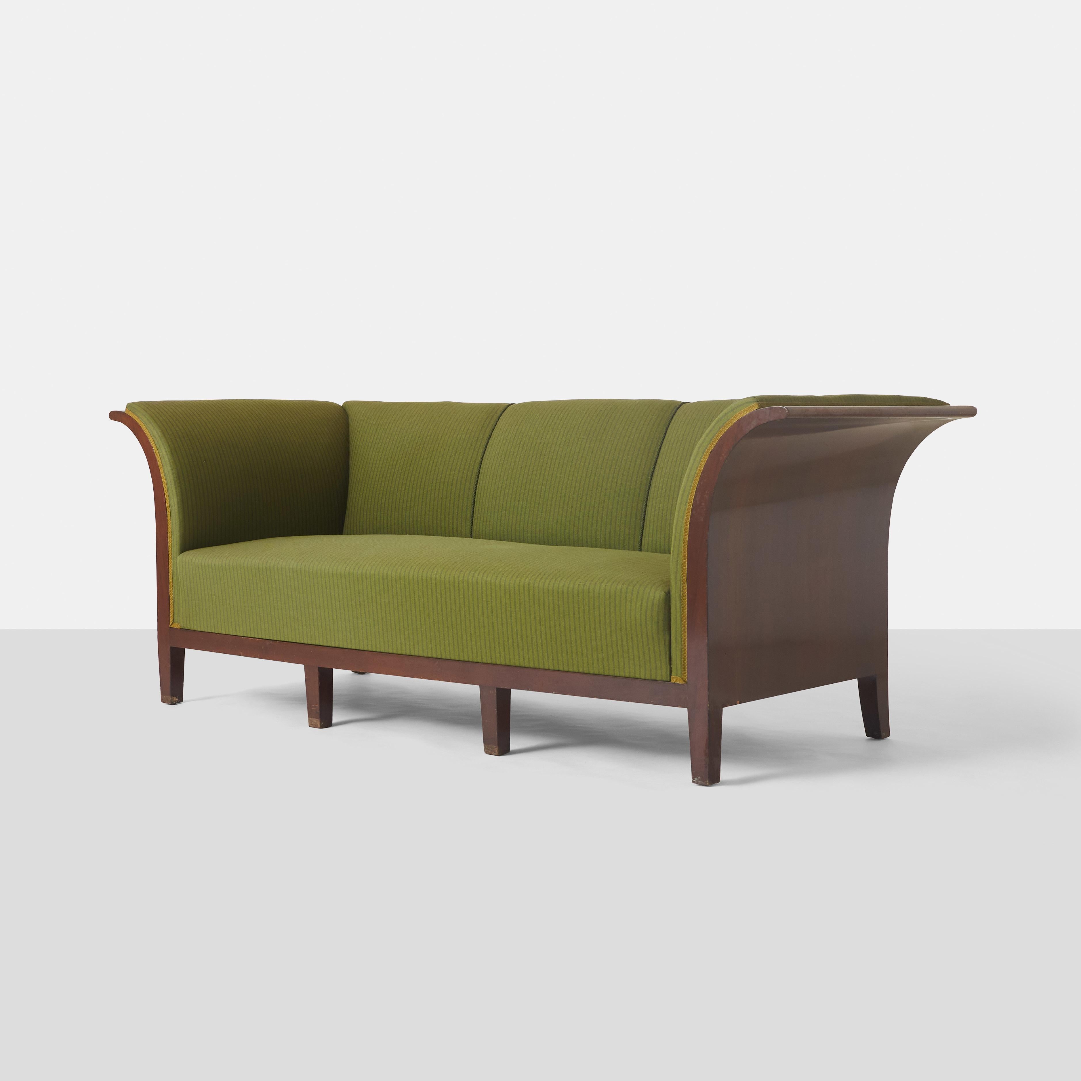 A three seater sofa designed and produced by Frits Henningsen with a mahogany frame, high back and curved armrests. 

The frame’s structure is sturdy, while the springs and upholstery are tired, making it an ideal candidate for restoration to