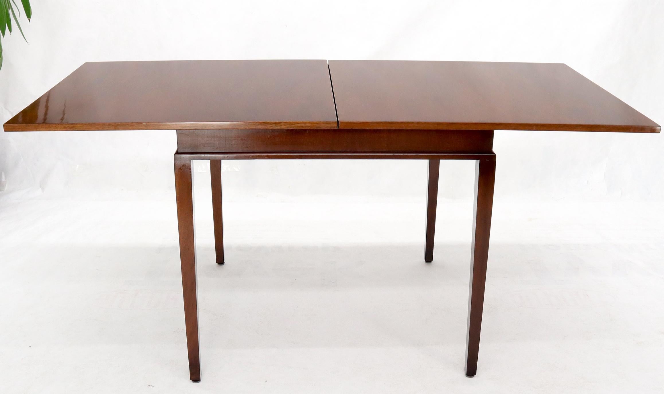 Mid-Century Modern mahogany square flip top game to dining table on square tapered legs.
