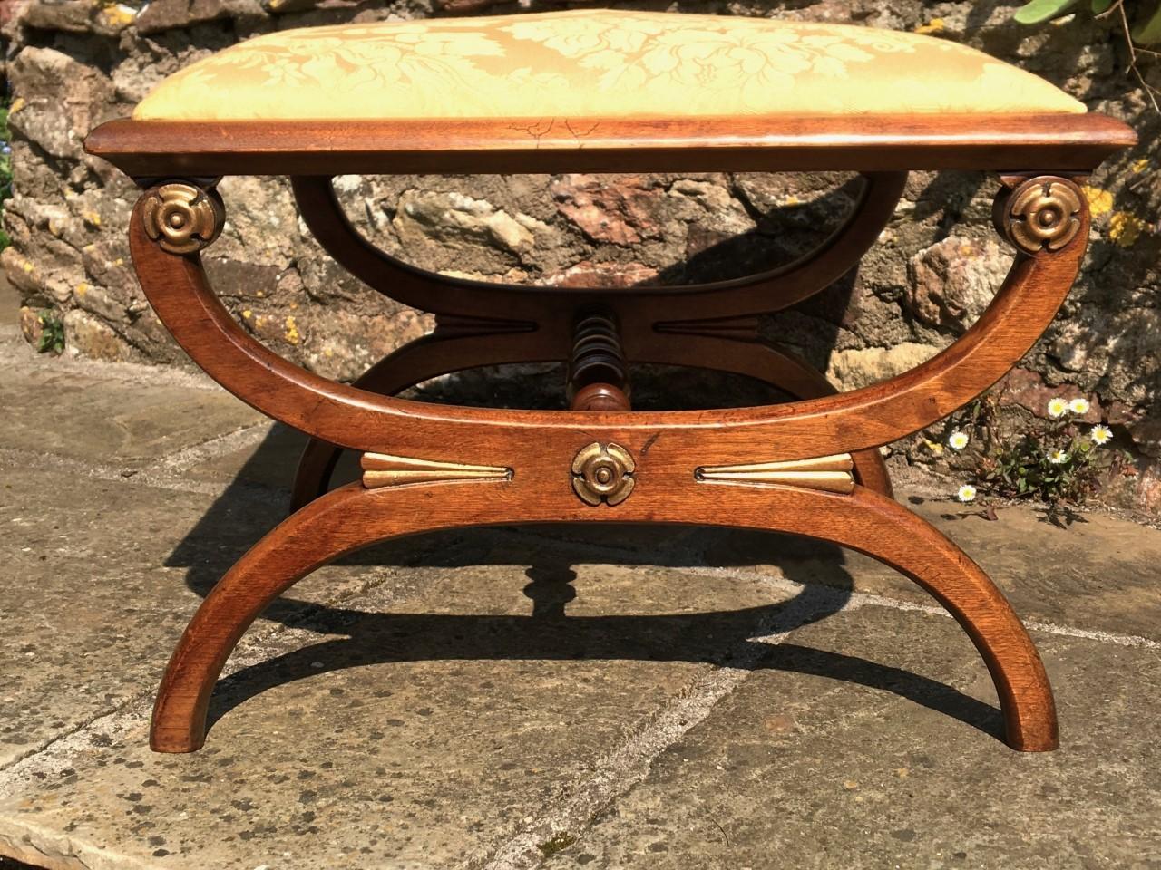A fine quality antique mahogany X-frame stool from the circa 1890s
This delightful stool has been lightly refurbished, cleaned and wax polished.
We have also had the seat completely upholstered in an attractive French
silk material in keeping with