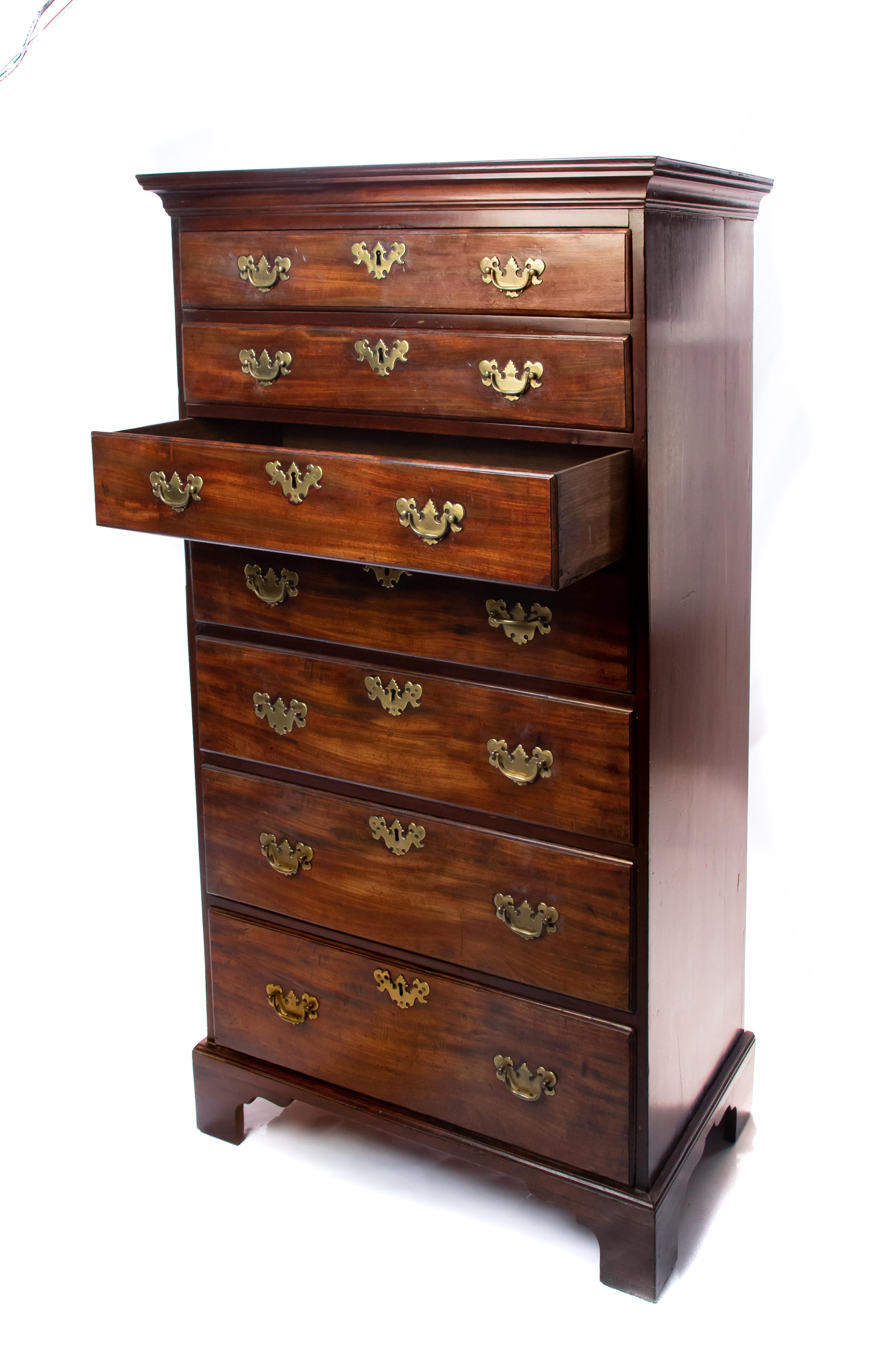 Offering this stunning tall chest in mahogany. Starting at the bottom on a bracket leg it rises. The narrow tall chest has seven drawers which have Chippendale pulls and hardware. The top of the chest finishes off beautifully with a dovetailed top