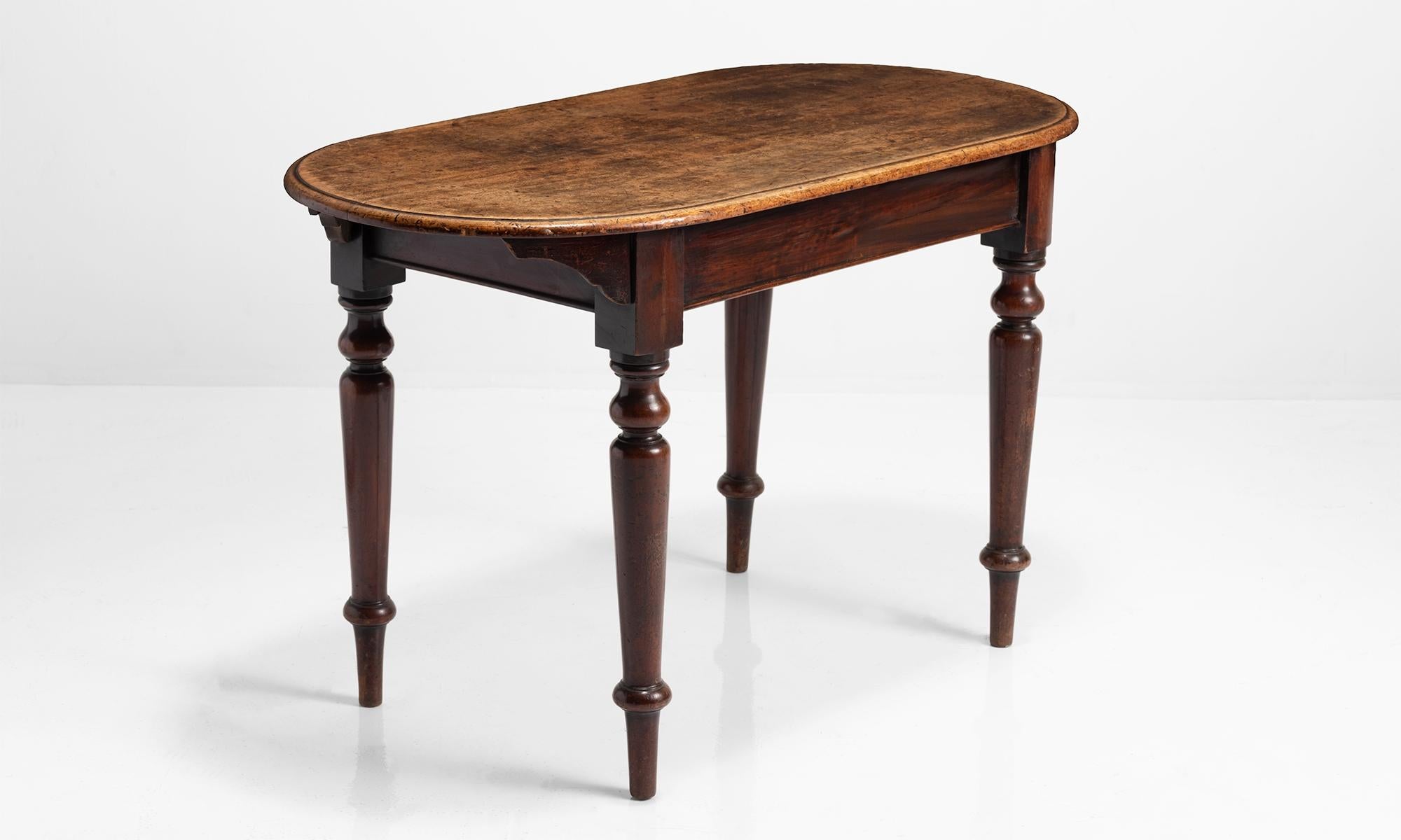 Mahogany Tavern table, England, 19th century.

Moulded mahogany tops with rounded ends on turned legs.