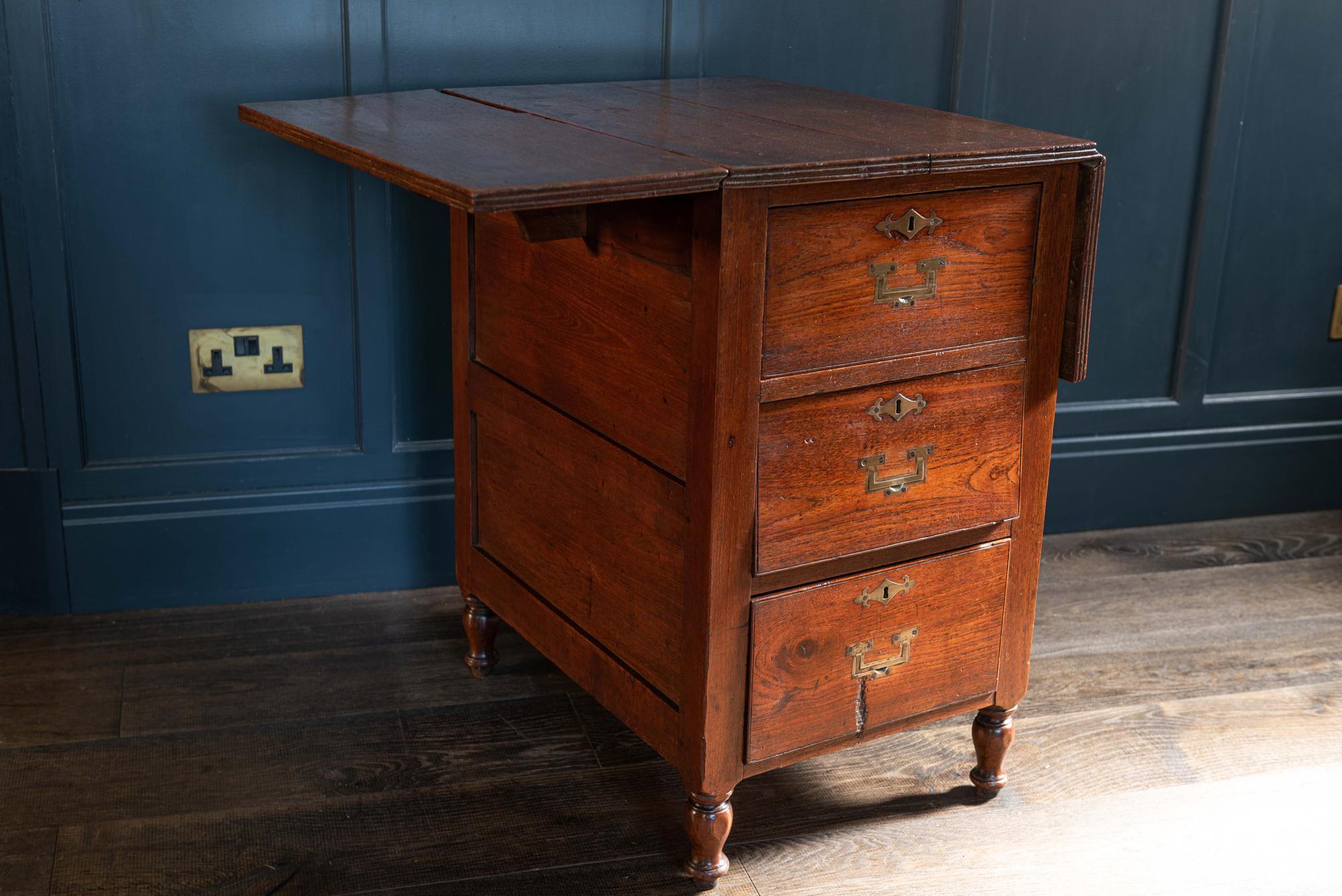 Mahogany and teak campaign cabin map table/chest. English, early 19th century.
The 3 slightly graduated dovetailed drawers have skeletal campaign handles and decorative escutcheons. Pegged construction, the sides and back of the table are panelled.