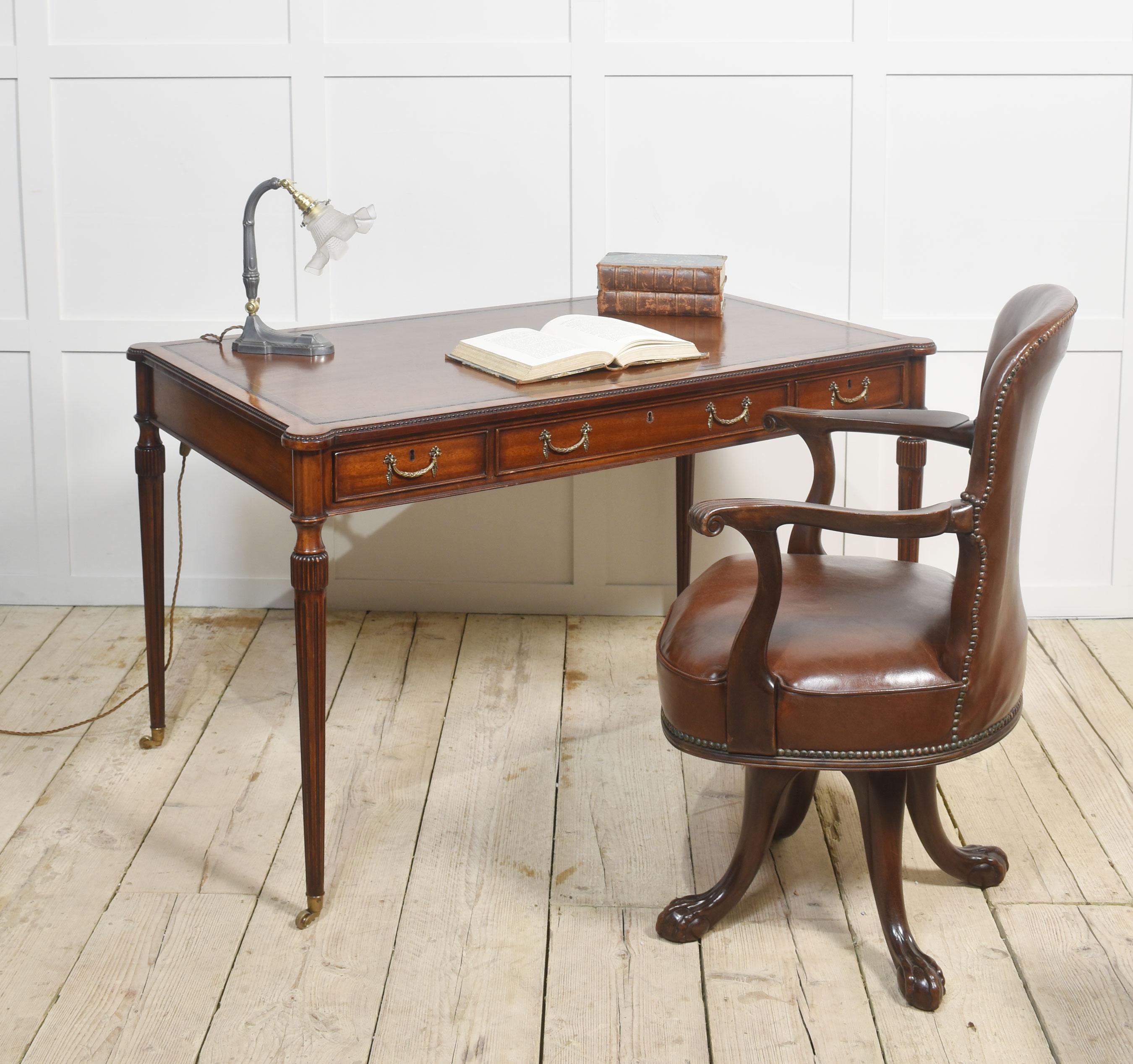 Mahogany three drawer writing table the rectangular top with inset brown tooled leather top above three drawers with brass handles. Raised up on reeded turned legs with brass casters united by shaped stretcher.
Dimensions
Height 30 Inches
Width 50