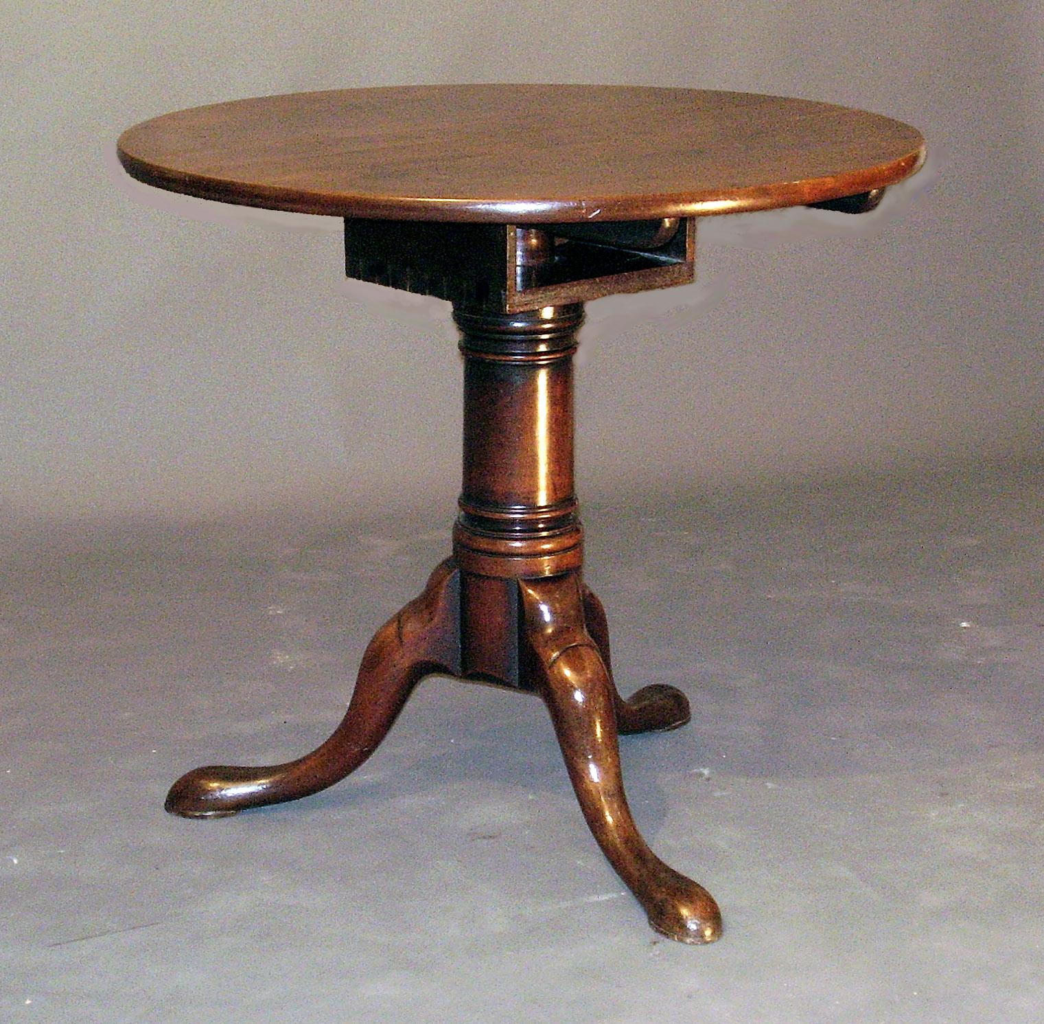 A George II tripod table with revolving one-piece top and a sturdy 'gun barrel' tripod stem, perhaps made to support a heavy bronze, mahogany of a good soft colour.